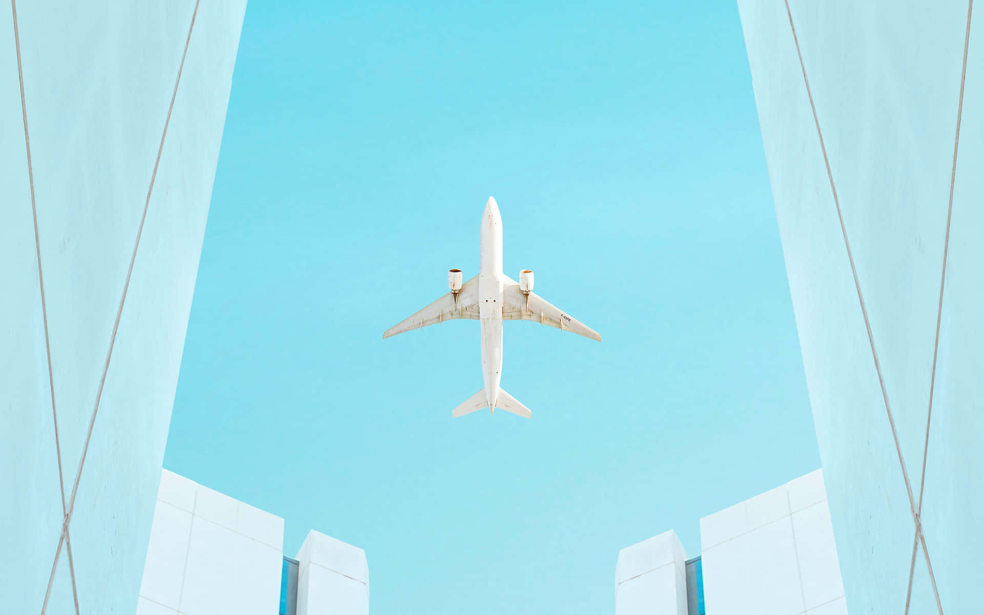 Airplane Framed By Buildings Sky View.jpg Wallpaper