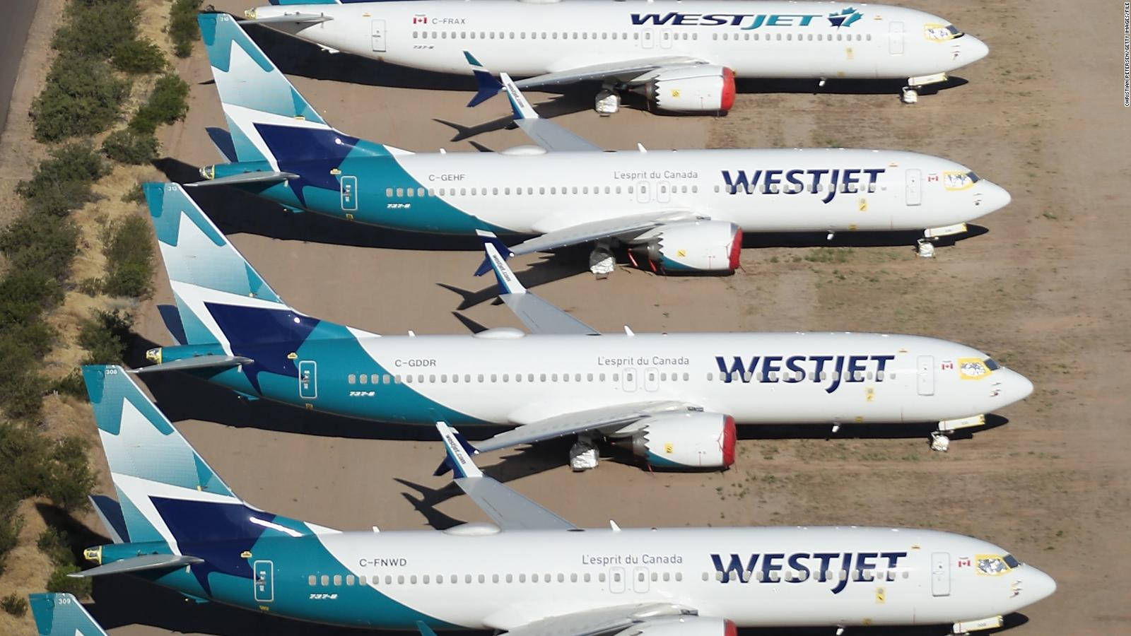 Flyvende plan af WestJet Airline på parkeringsrampe Wallpaper