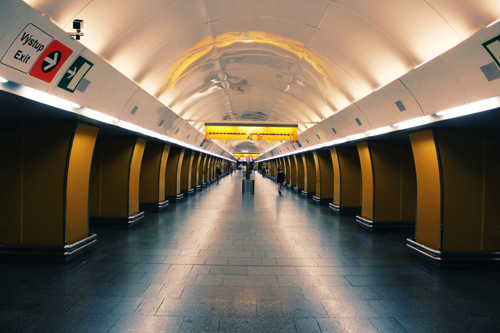 A Long Hallway With A Yellow Ceiling