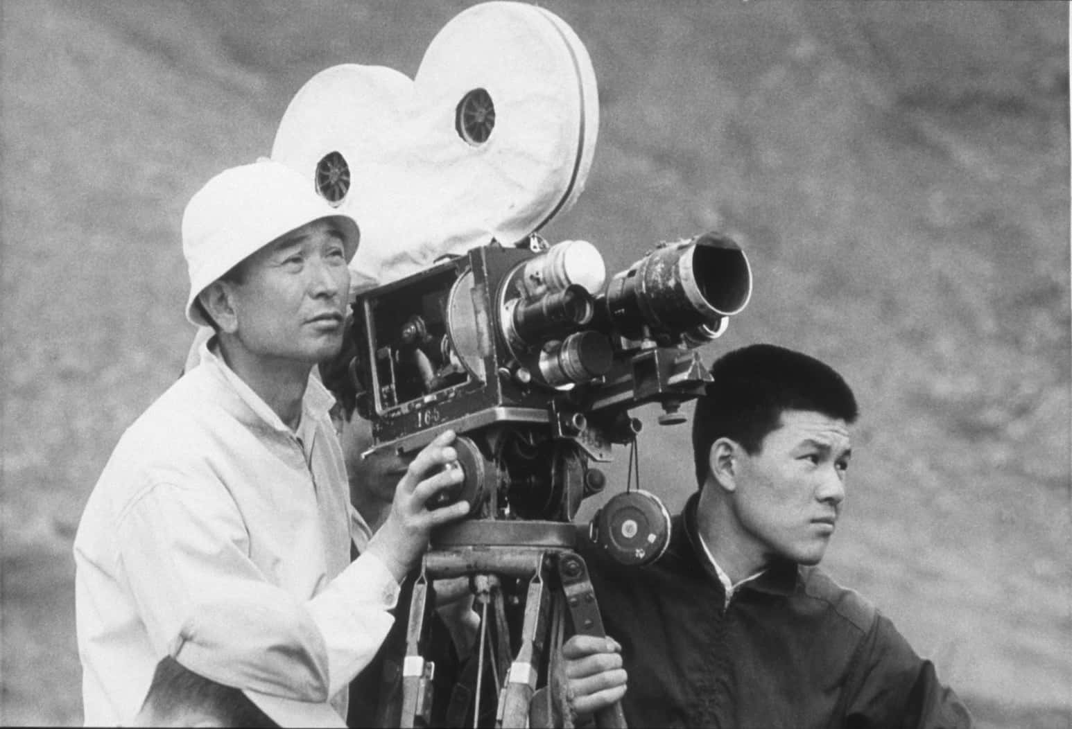 Akira Kurosawa deep in thought on set Wallpaper