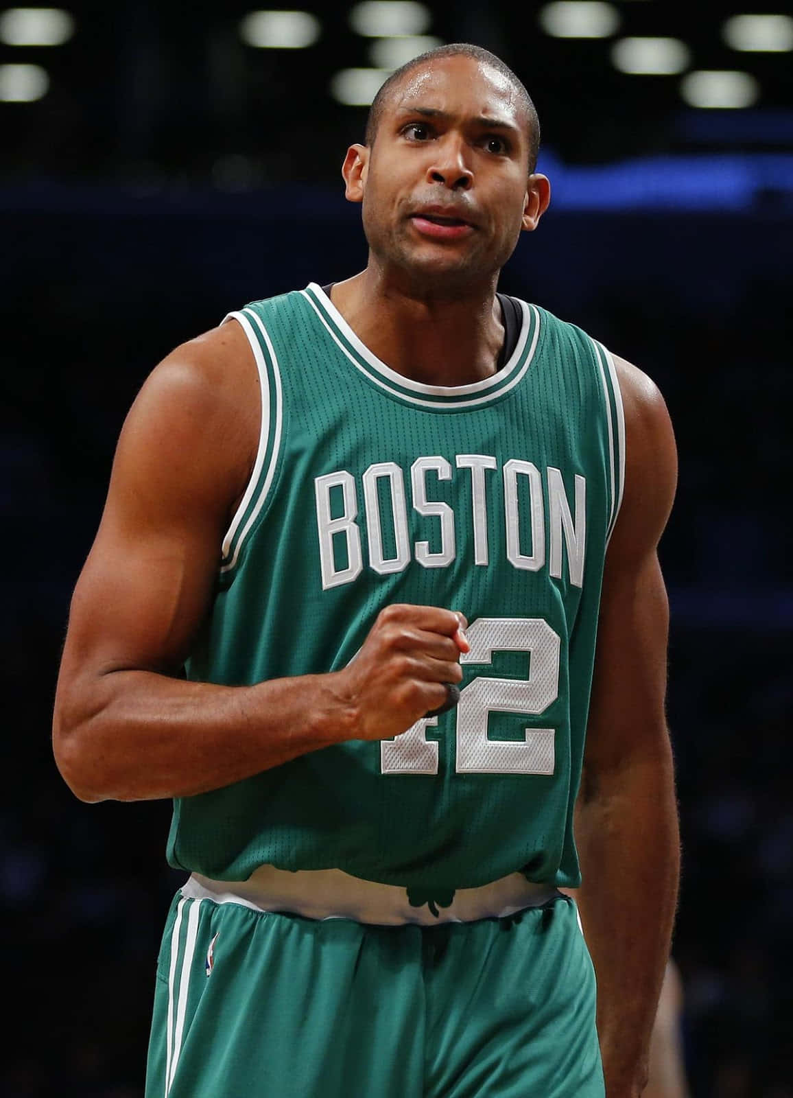Al Horford looks towards the court with determination