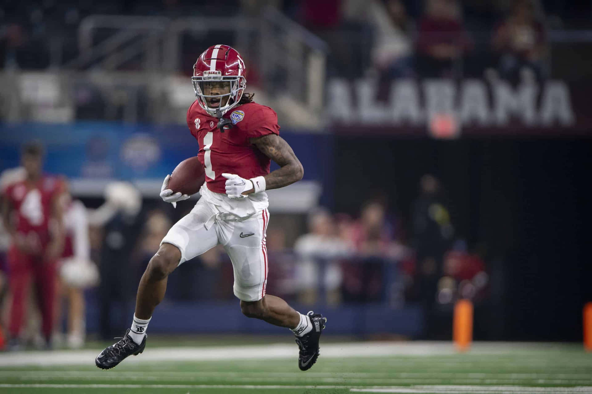 Alabama Football Player Running With Ball Wallpaper