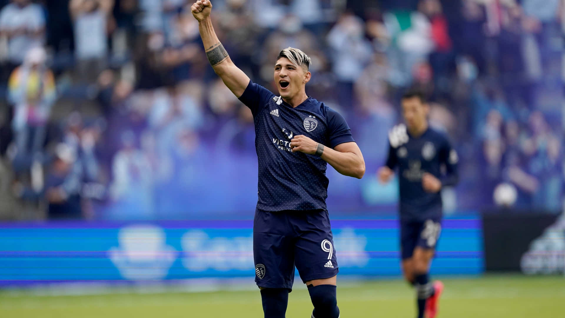 Alan Pulido Celebrating With Fist Up Wallpaper