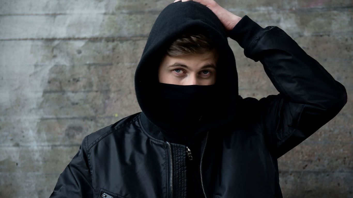 Alan Walker performing live on stage in a captivating scene