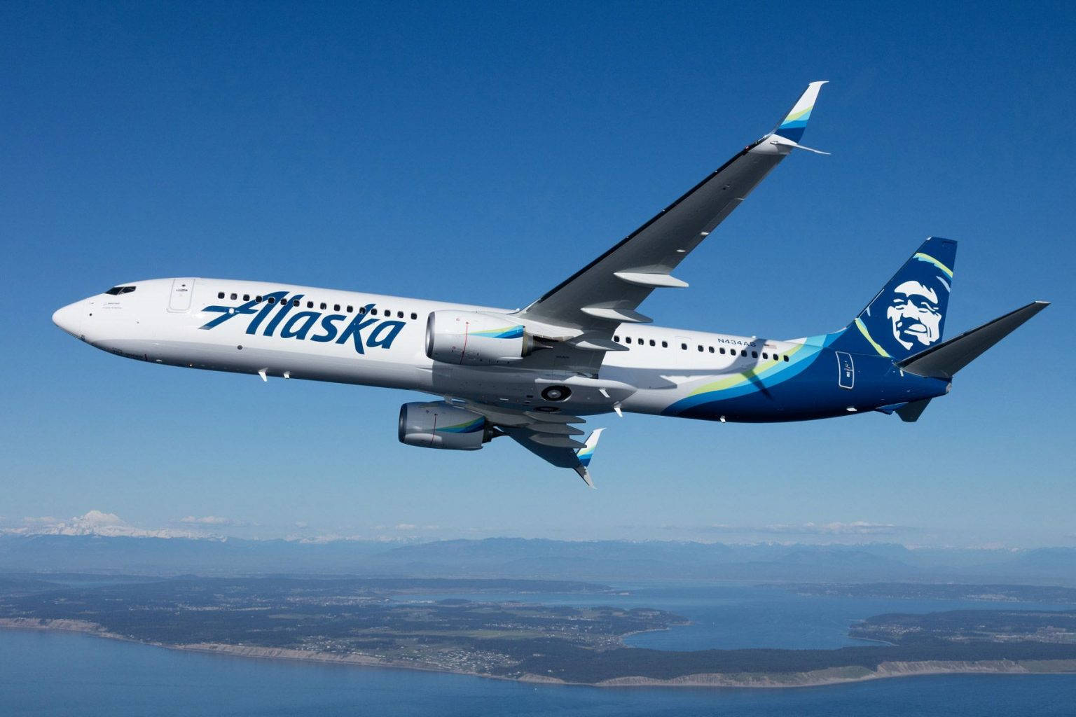 Alaska Airlines Soaring Above The Sea Wallpaper