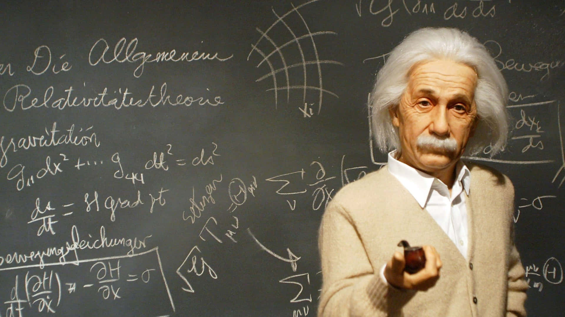 Albert Einstein - A Statue In Front Of A Chalkboard
