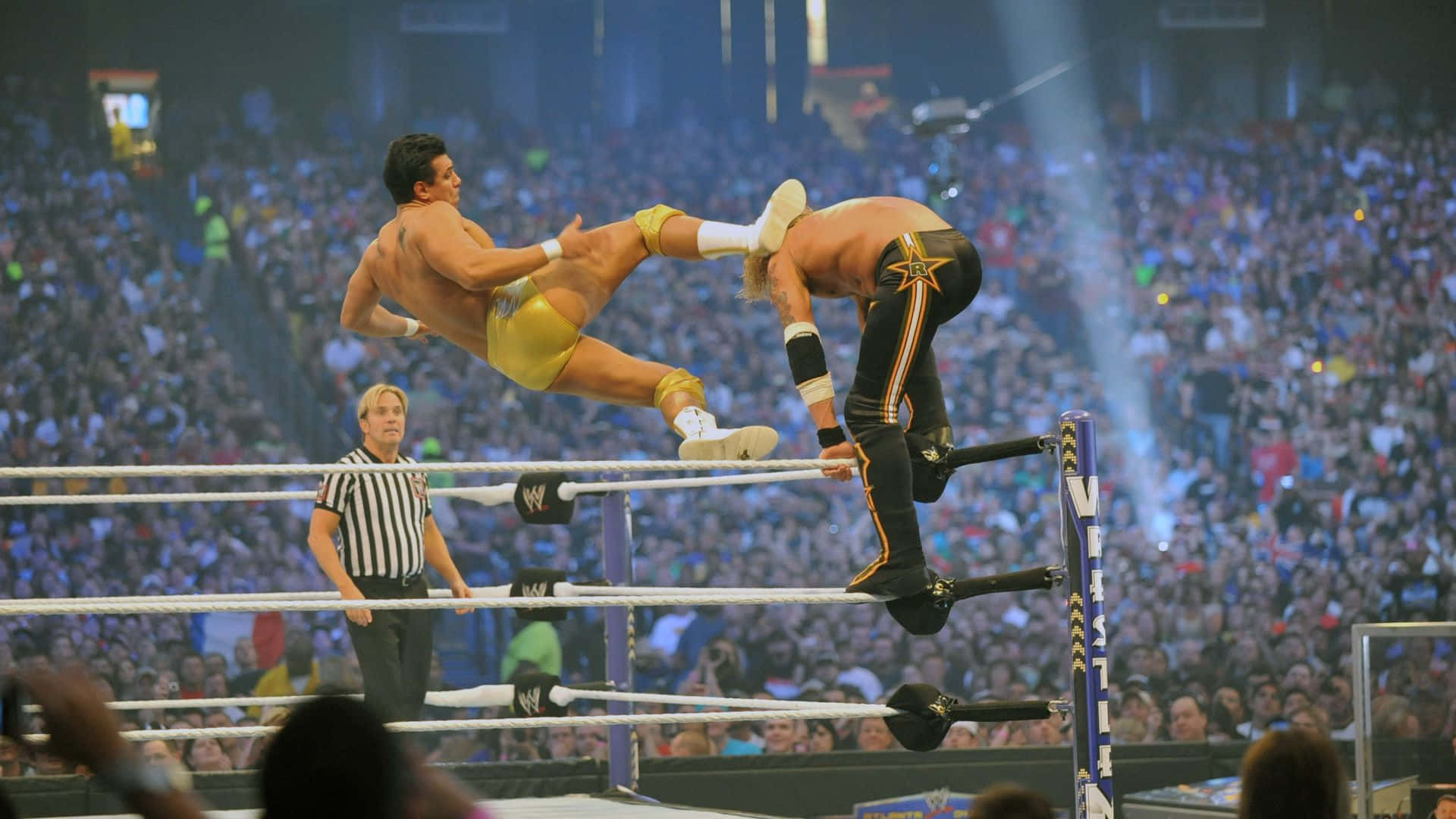 Alberto Del Rio executing a dramatic kick on his opponent in the WWE ring Wallpaper