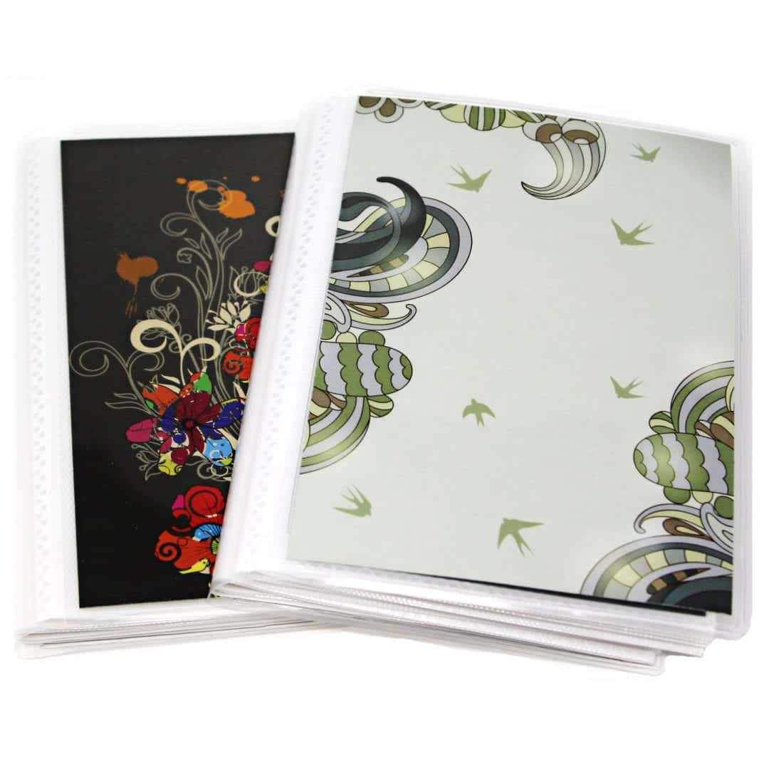 a stack of white folders with designs on them
