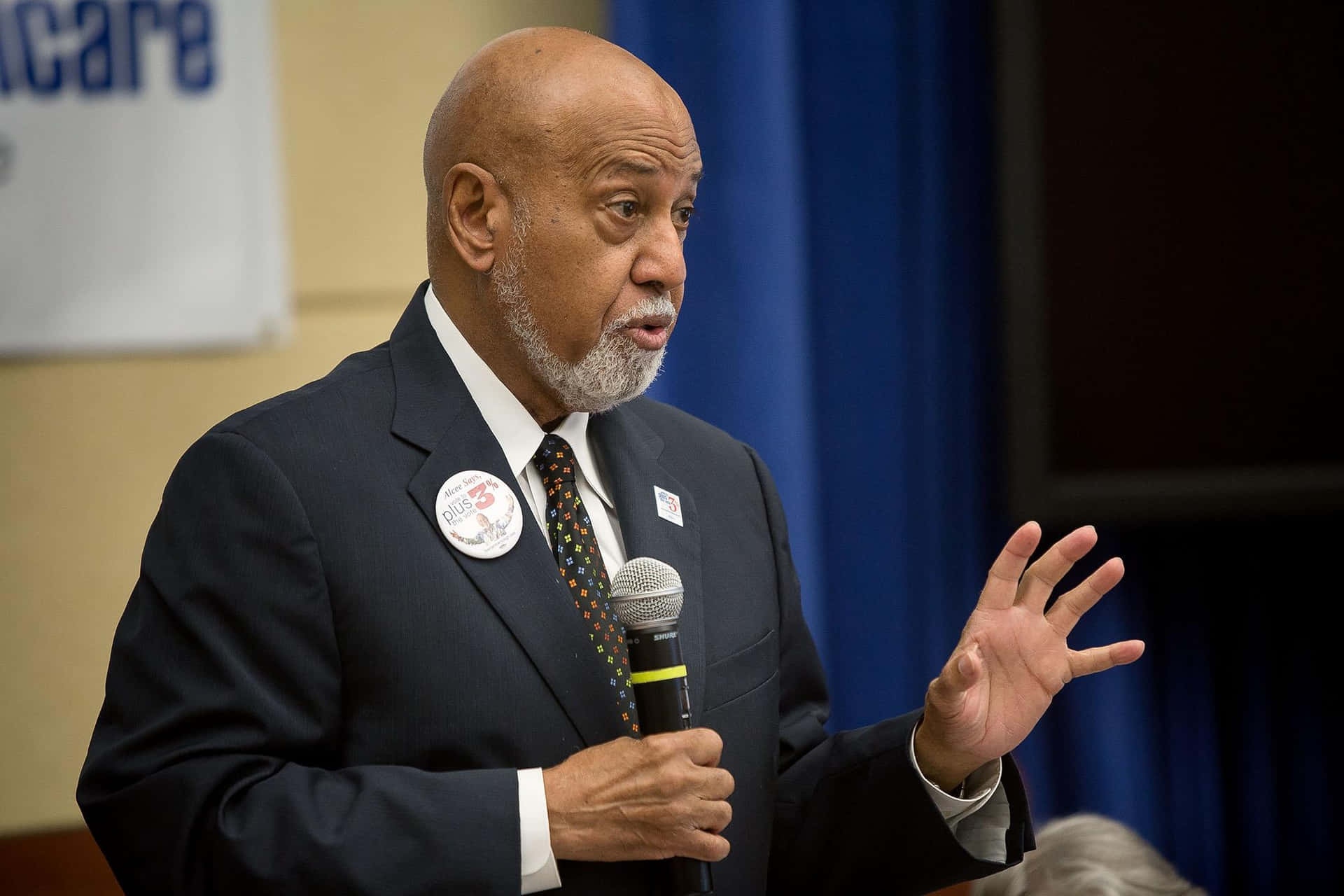 Alcee Hastings passionately delivering a speech to an engaged audience. Wallpaper