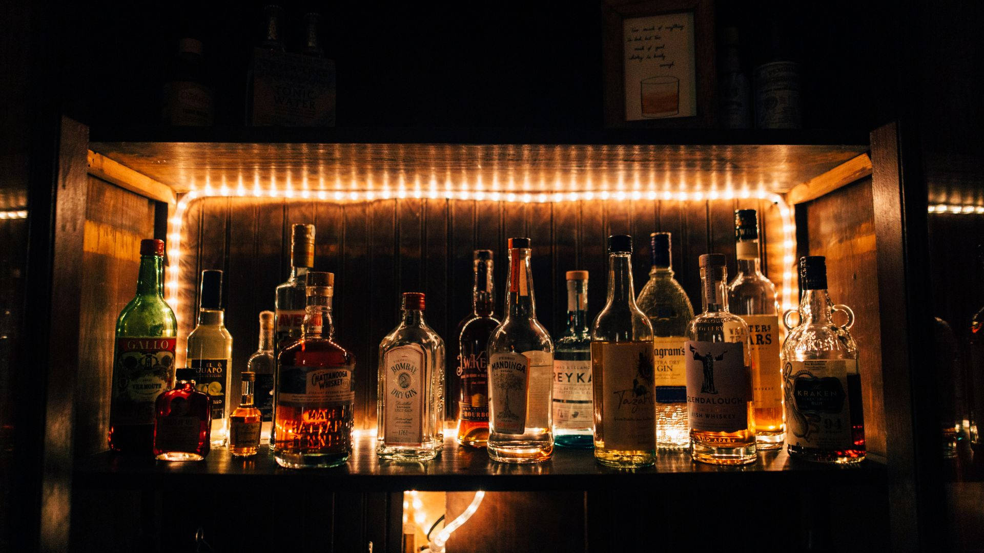 Alcohol Bottles On Shelf With Light Picture