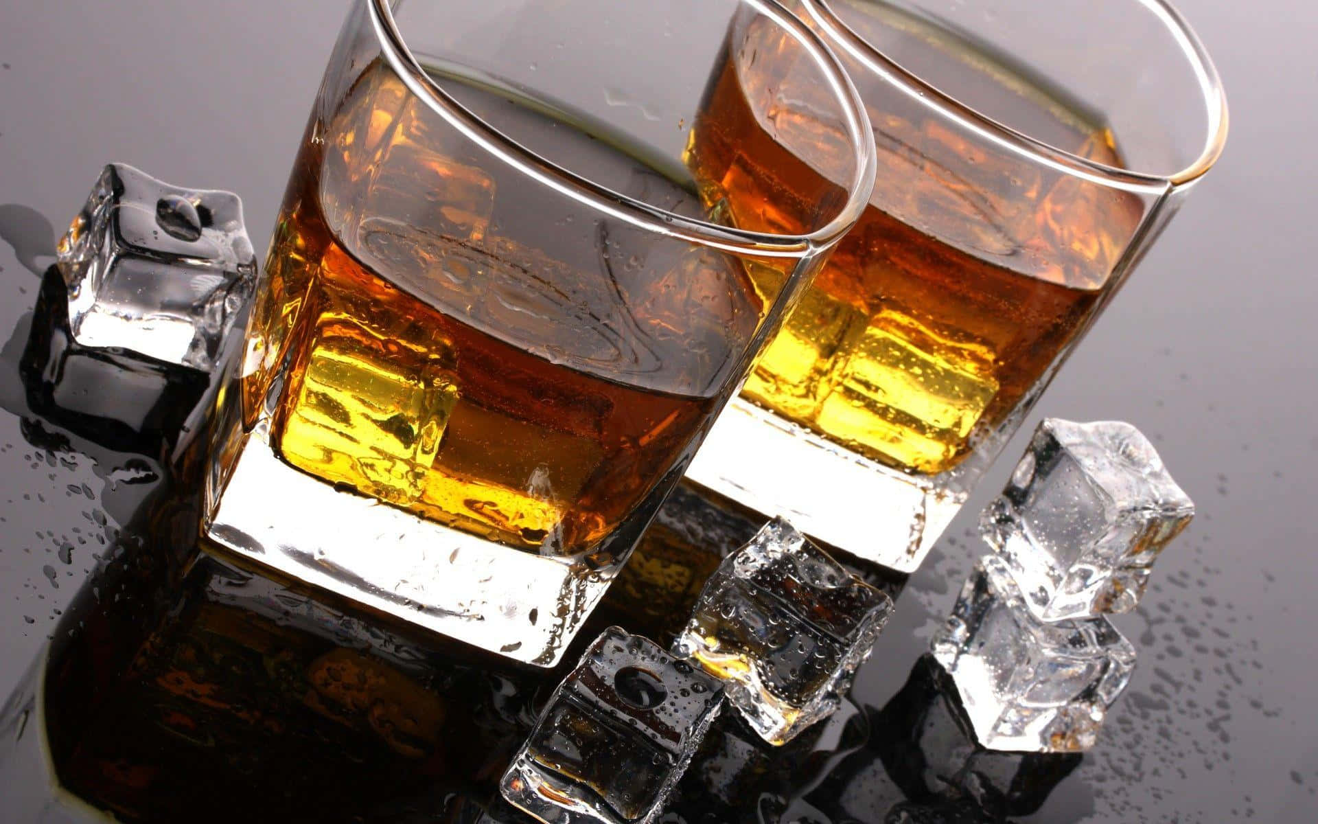 Two Glasses Of Whiskey With Ice Cubes