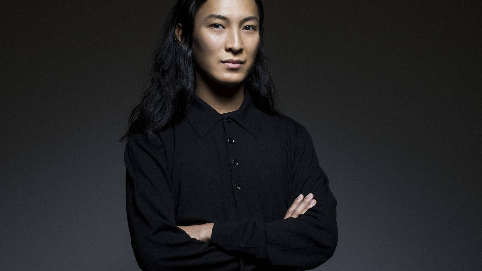 Fashion Designer Alexander Wang confidently standing with arms crossed Wallpaper