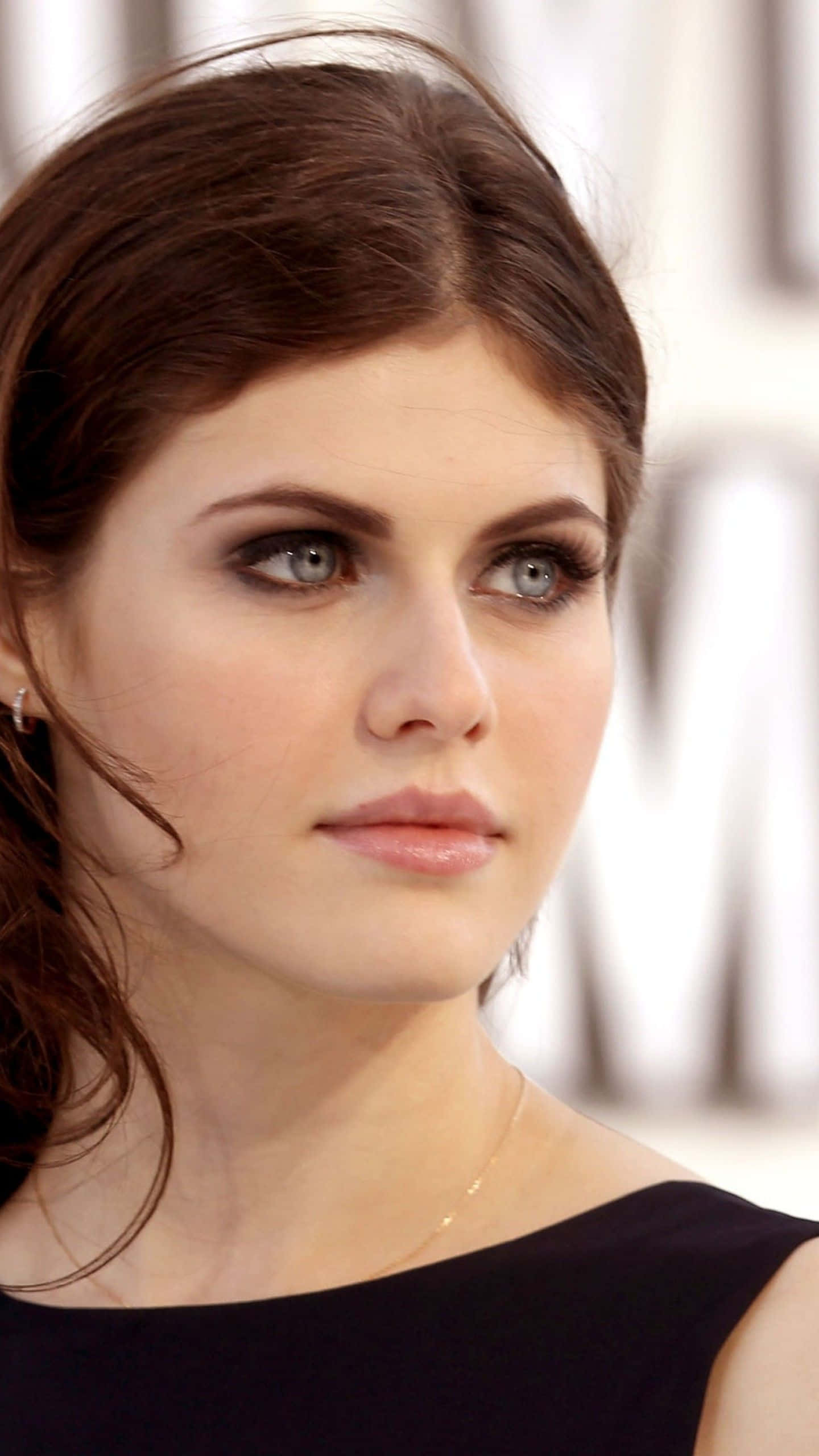 Stunning Alexandra Daddario posing in a chic outfit