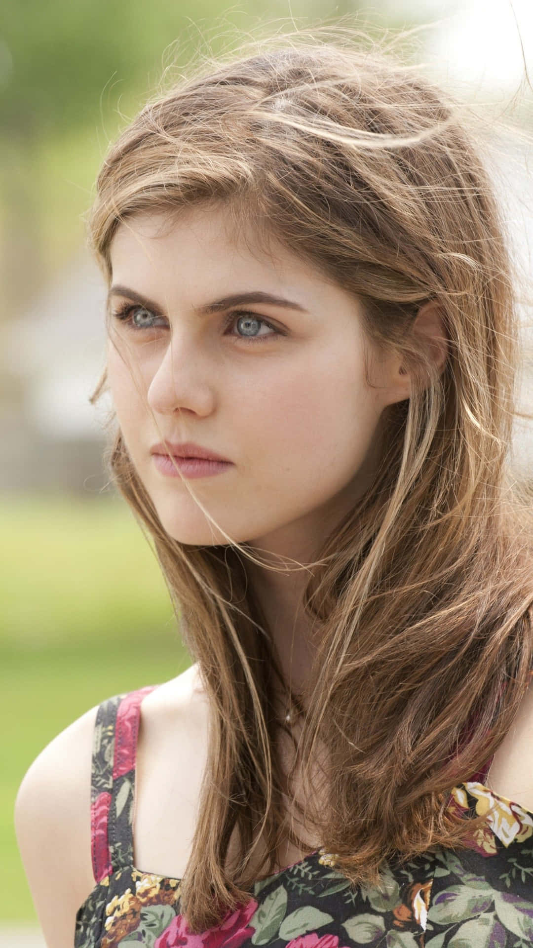 Stunning Alexandra Daddario Poses Elegantly Against a Nature-Inspired Background