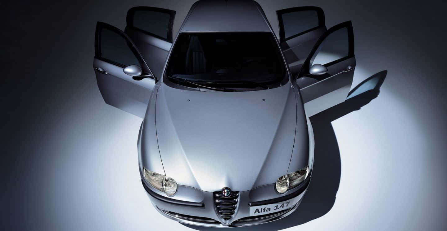 Download Caption: Sleek Alfa Romeo 147 in Red Wallpaper