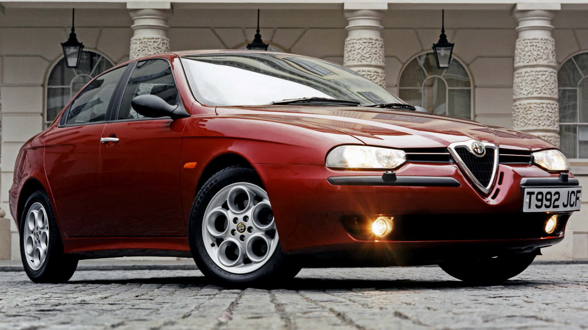 Sleek Alfa Romeo 156 against a breathtaking backdrop Wallpaper