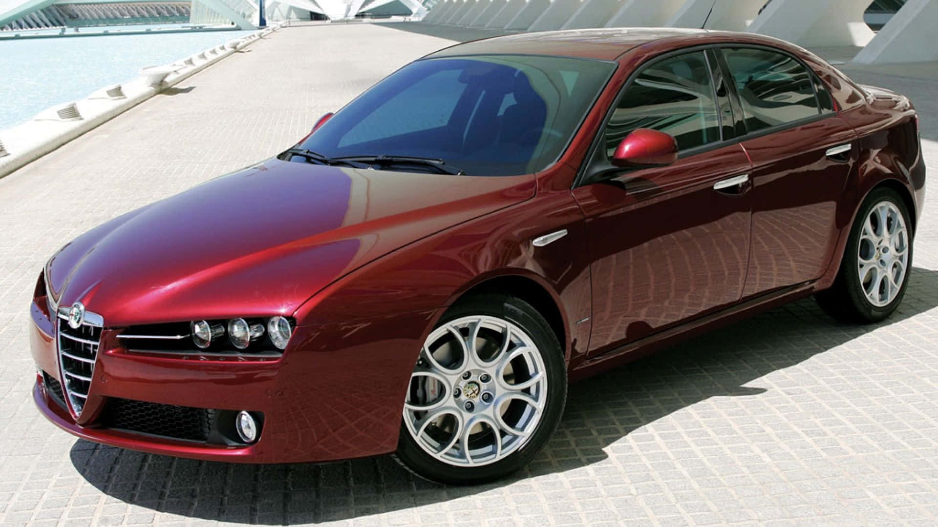 Alfa Romeo 159 Luxury Sports Sedan Driving on Road Wallpaper