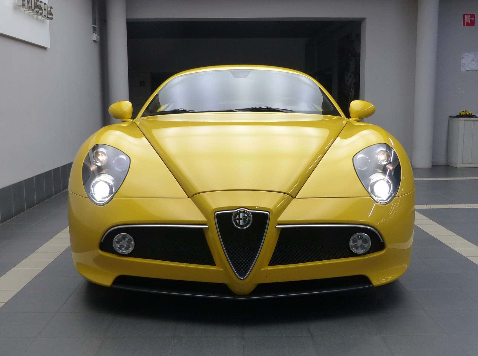 Sleek Alfa Romeo 8c Competizione in motion Wallpaper