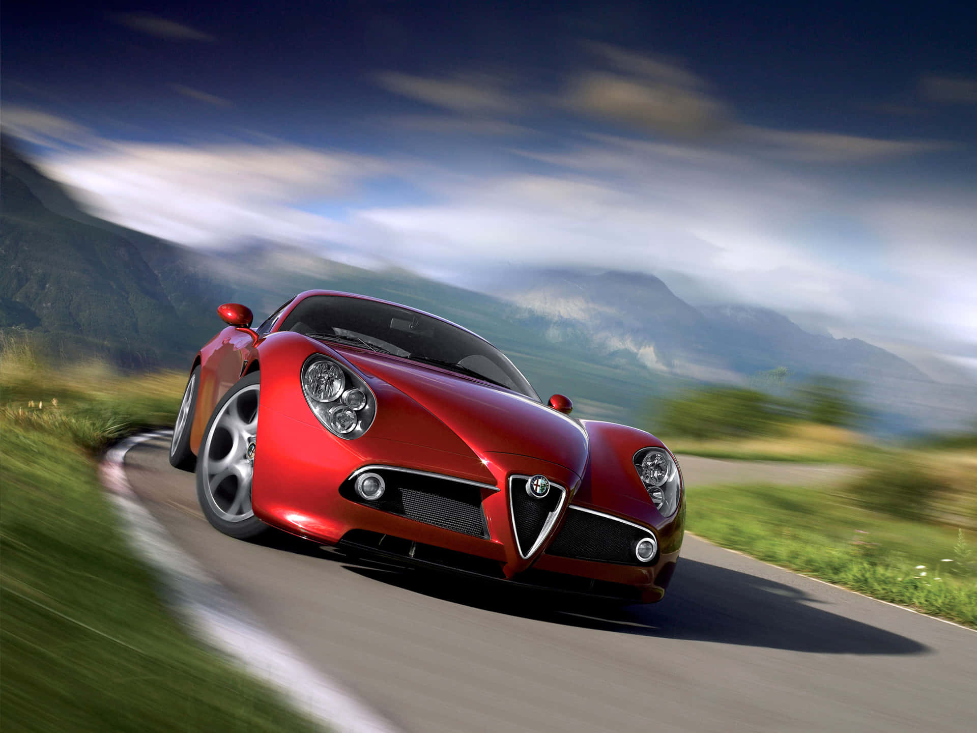 Alfa Romeo 8C Competizione in a striking red color on the road Wallpaper