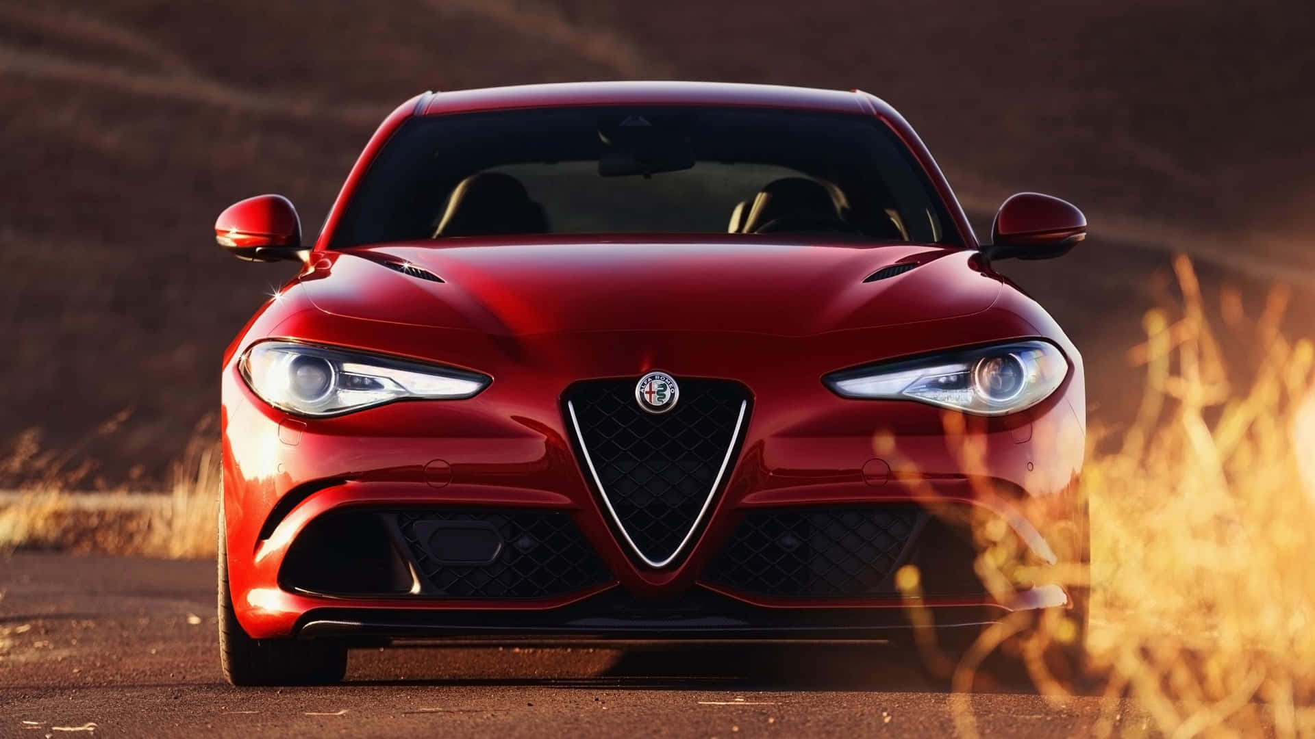 Sleek Alfa Romeo Giulia in Vibrant City Background Wallpaper