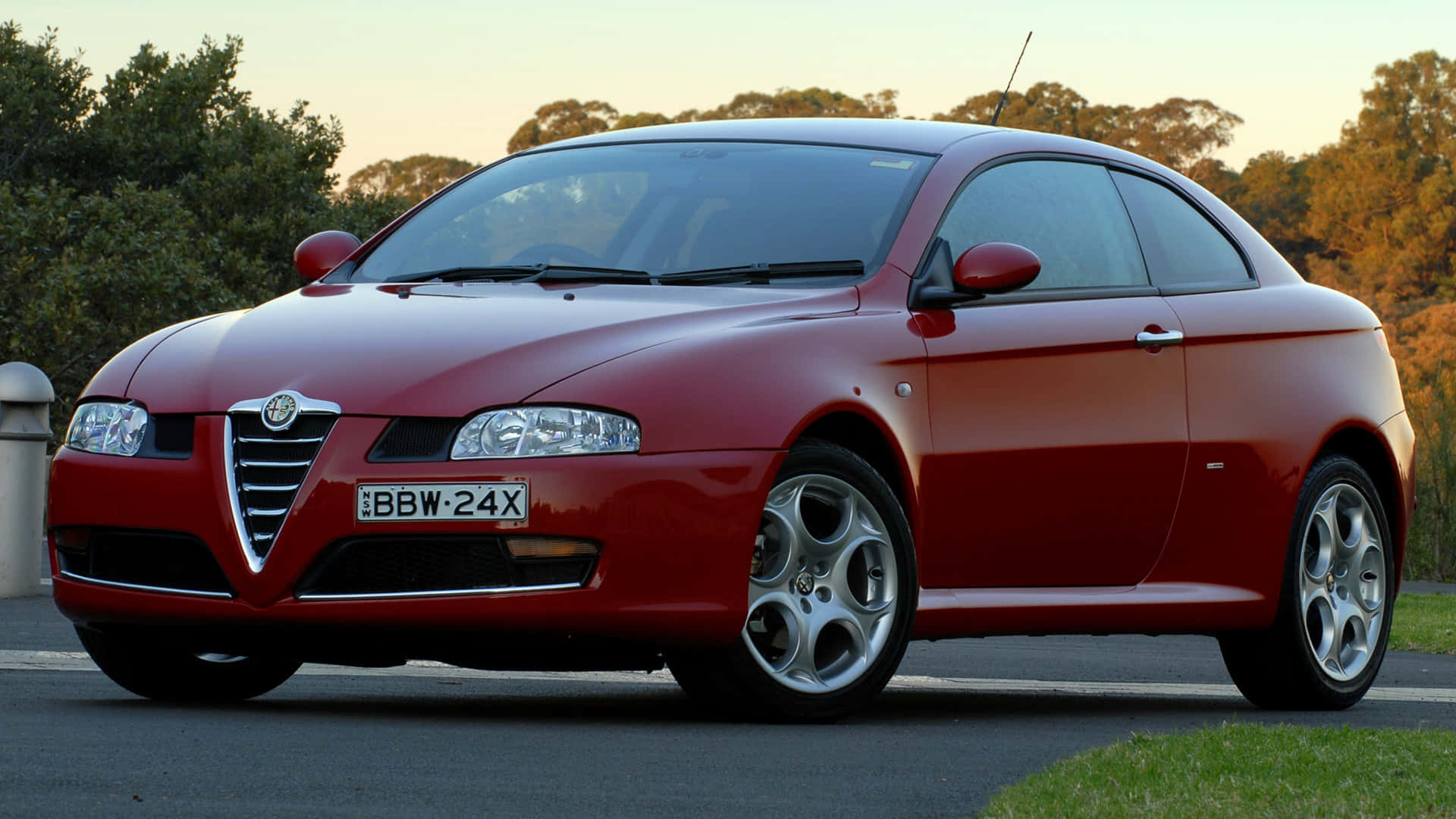 Caption: Sleek Alfa Romeo GT in action on the road Wallpaper