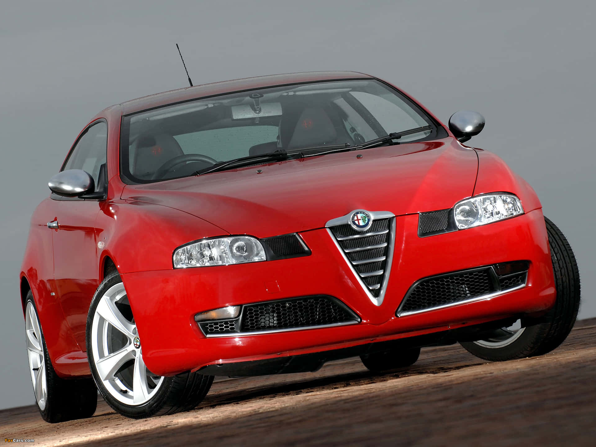 Sleek Alfa Romeo GT in a breathtaking setting Wallpaper