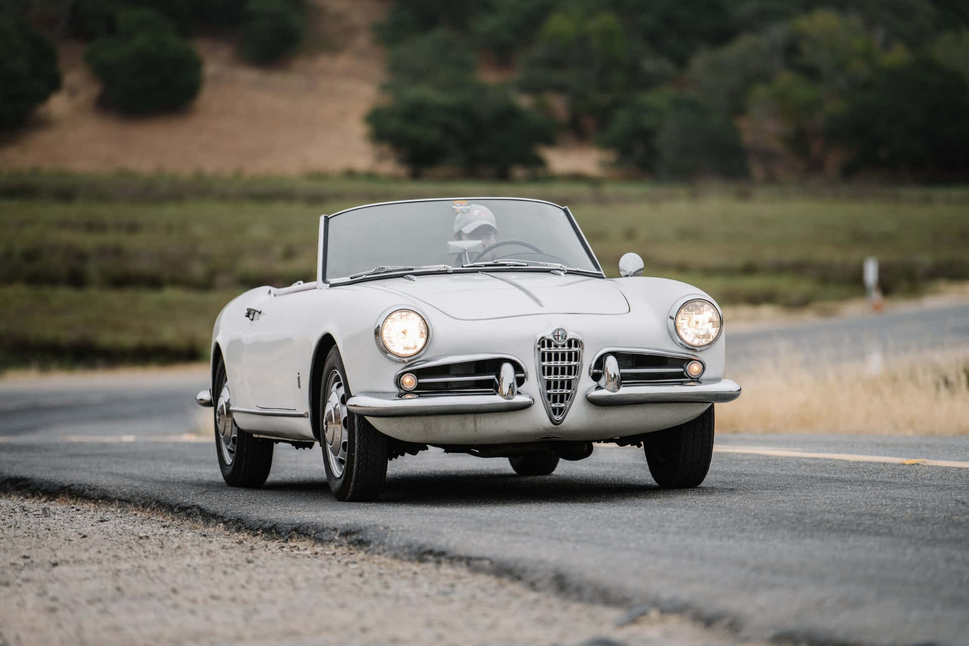 Sleek Alfa Romeo Spider in a breathtaking scenic backdrop Wallpaper