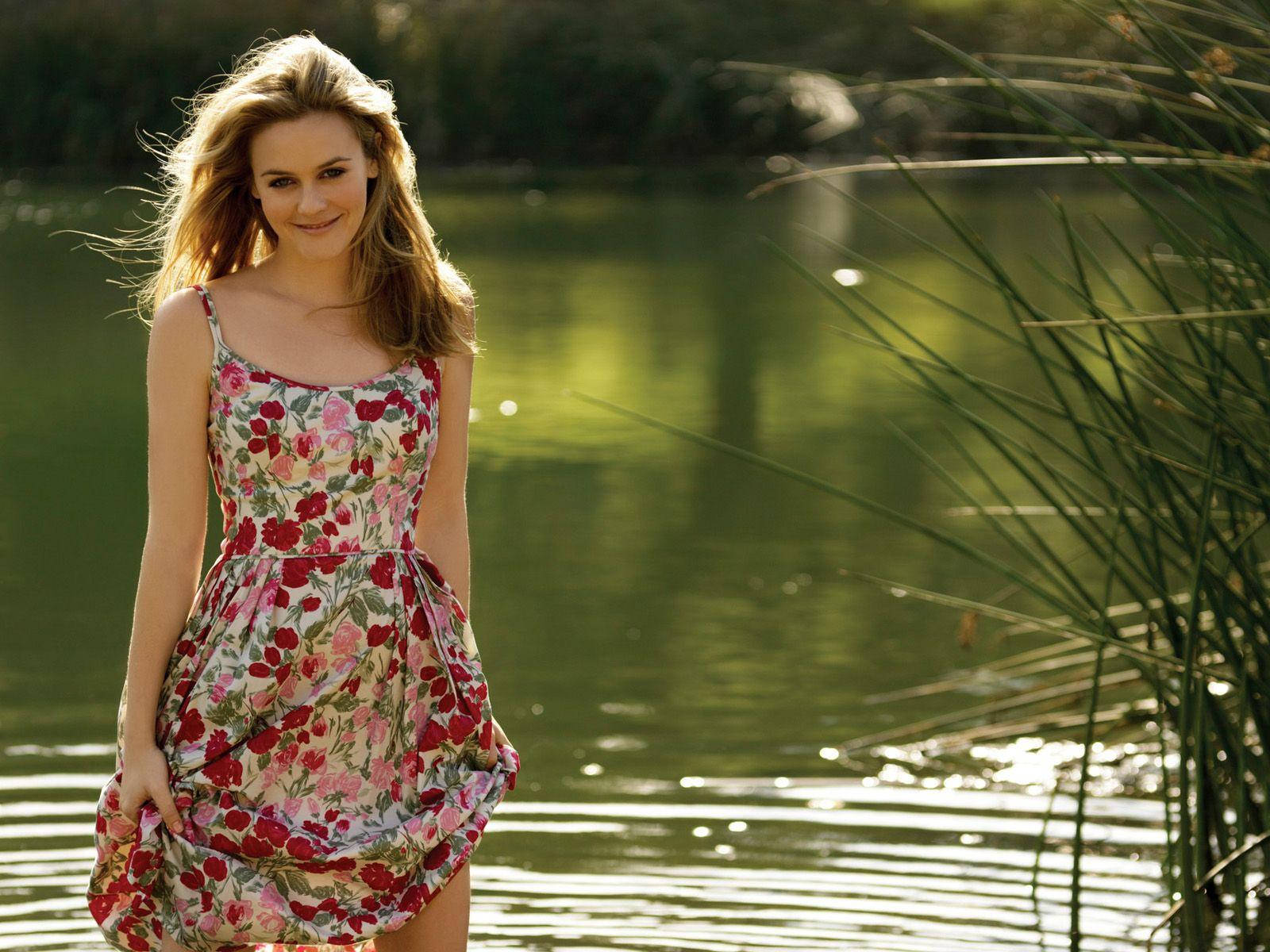 Alicia Silverstone In Front Of The Lake Wallpaper