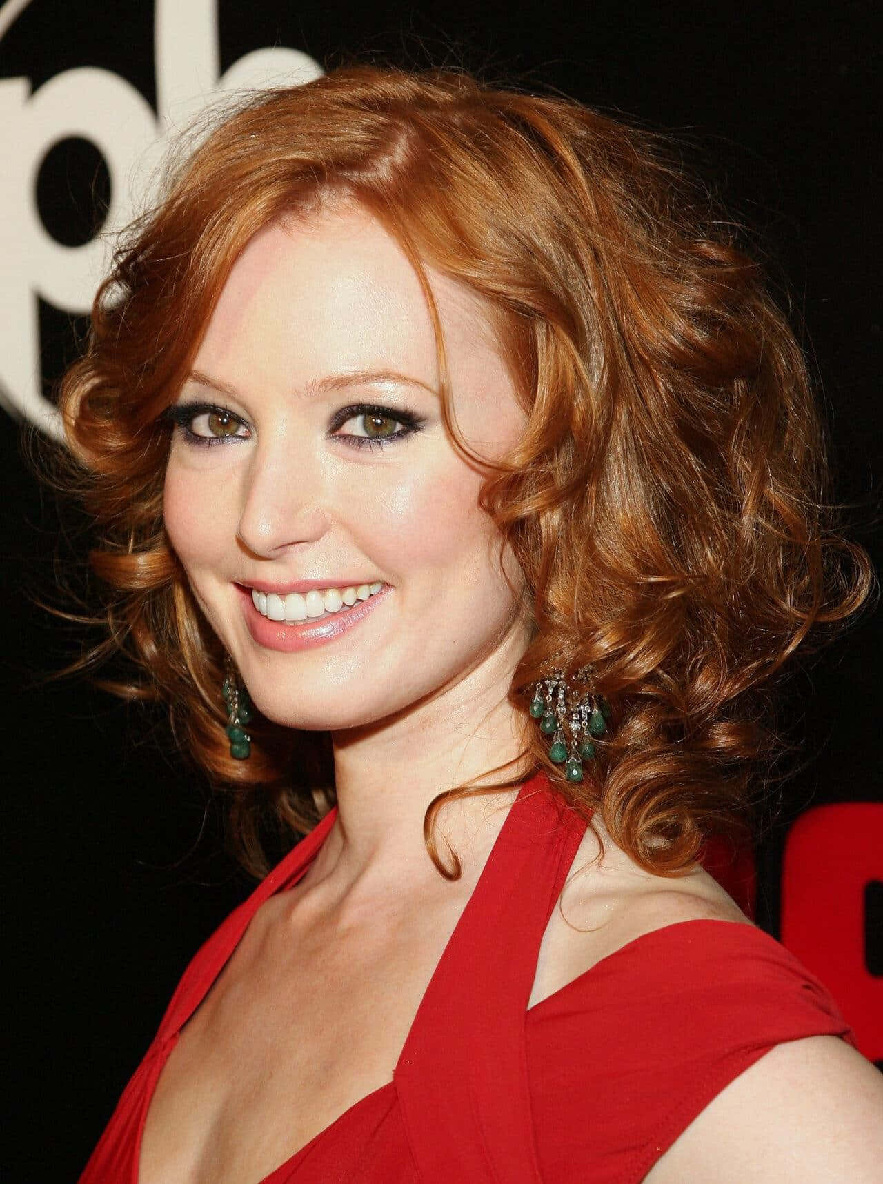 Alicia Witt Smiling in Red Outfit Wallpaper