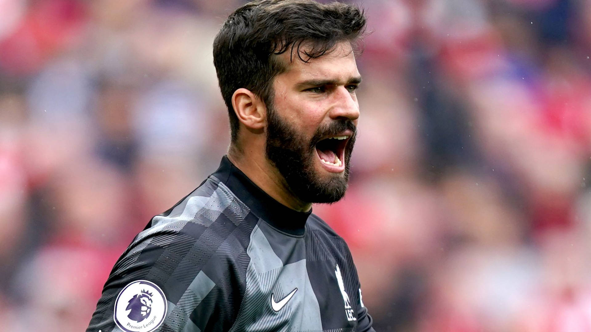 Passionate Goalkeeper Alisson Becker Expresses Intensity On the Field Wallpaper