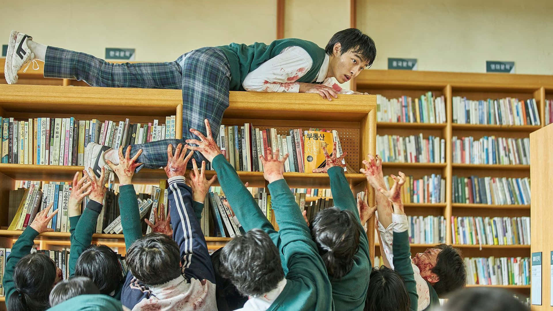 A Group Of Students Are Jumping On Top Of A Book Shelf
