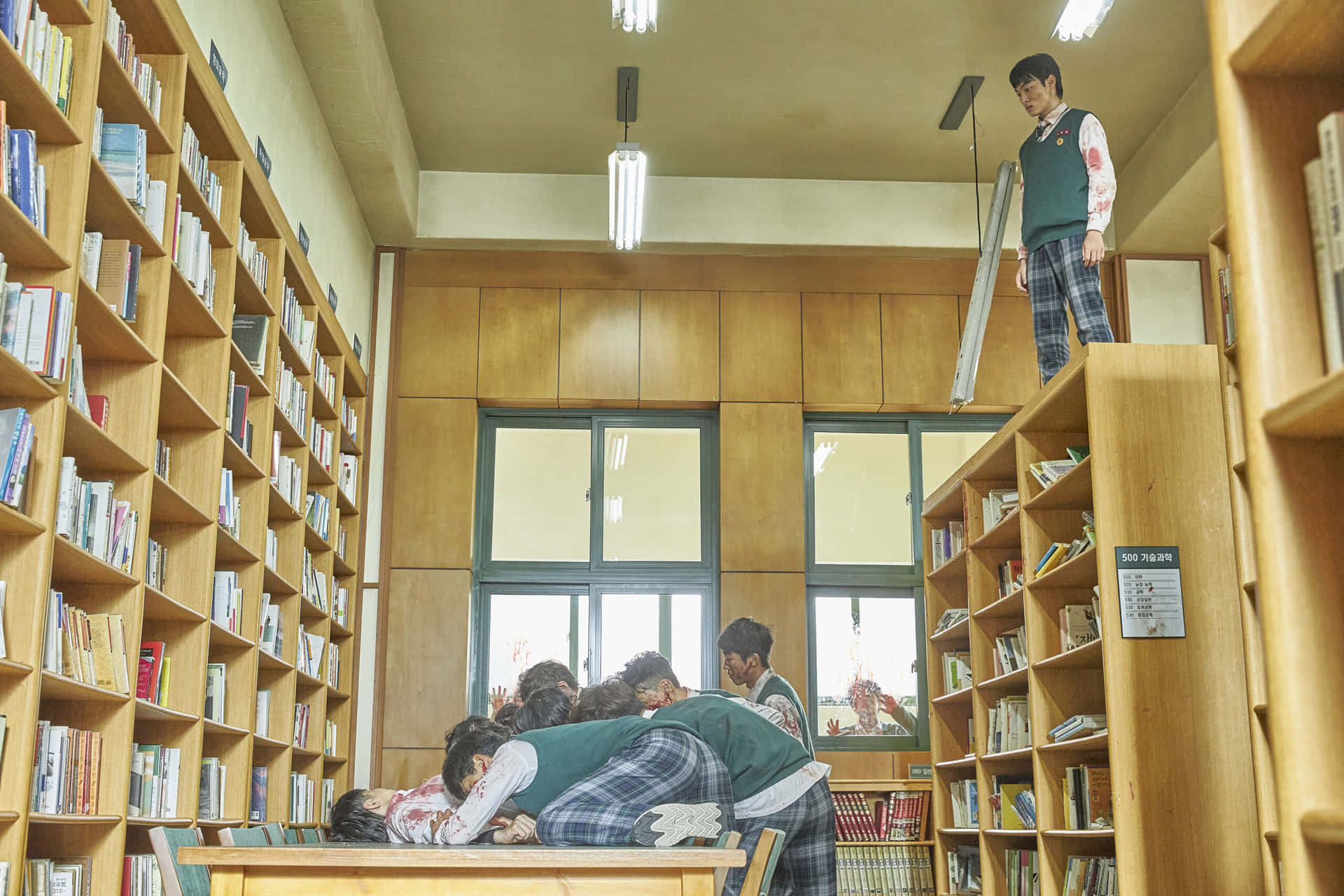 A Group Of Children Are Sitting In A Library