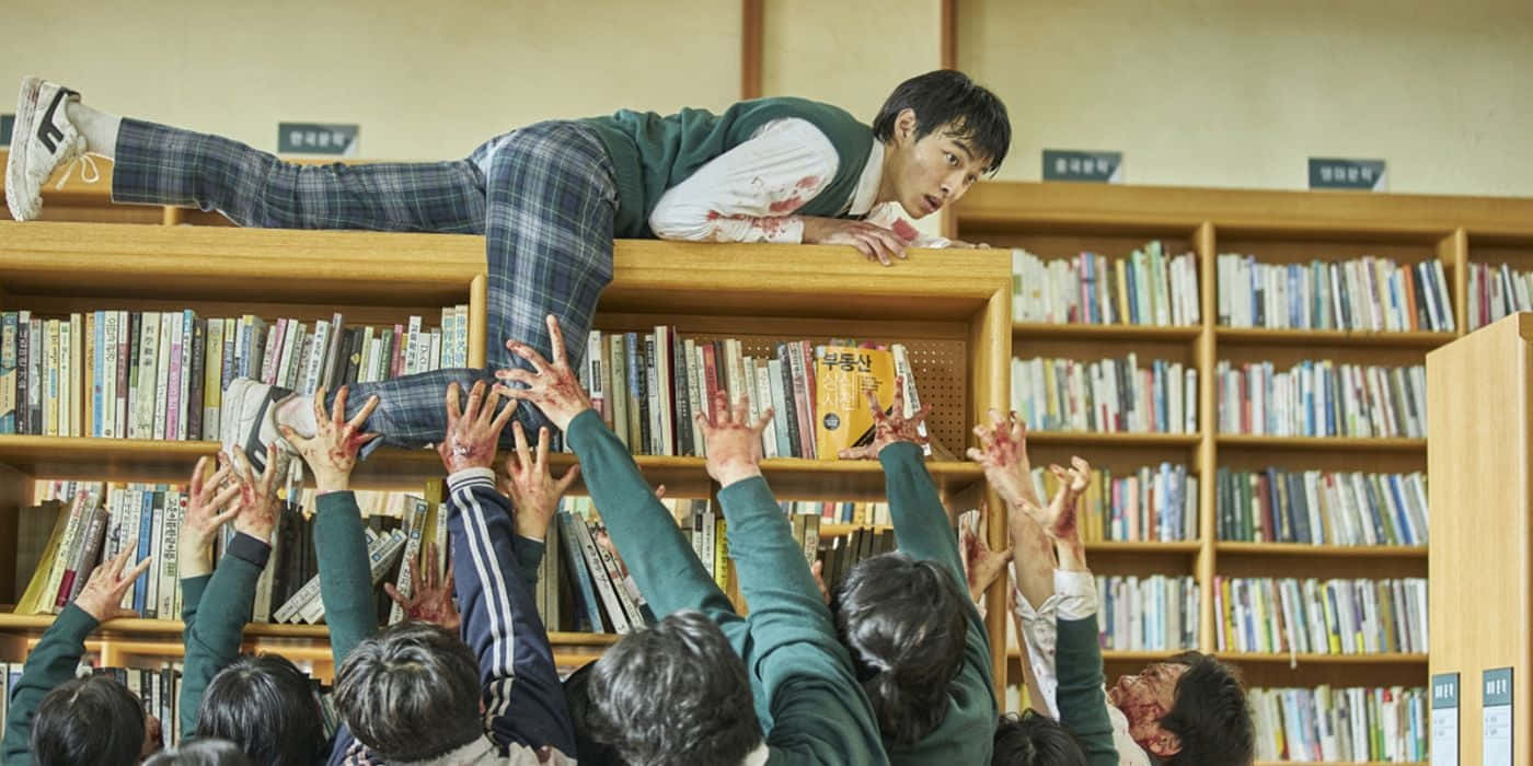 A Group Of Children Are Jumping Over A Book Shelf