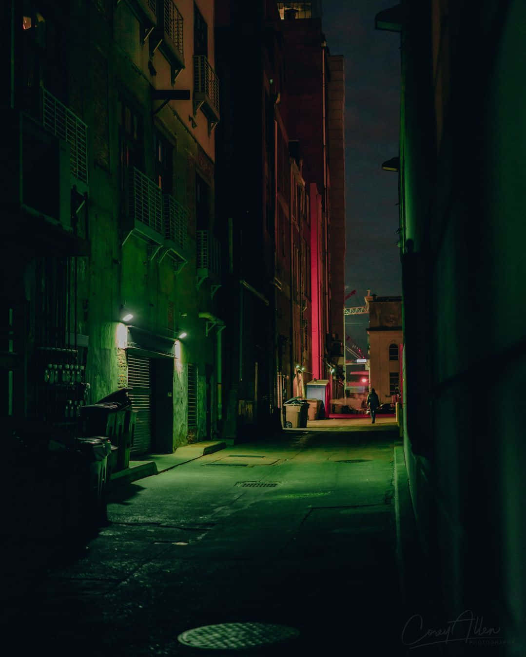 A Street With Buildings And A Green Light
