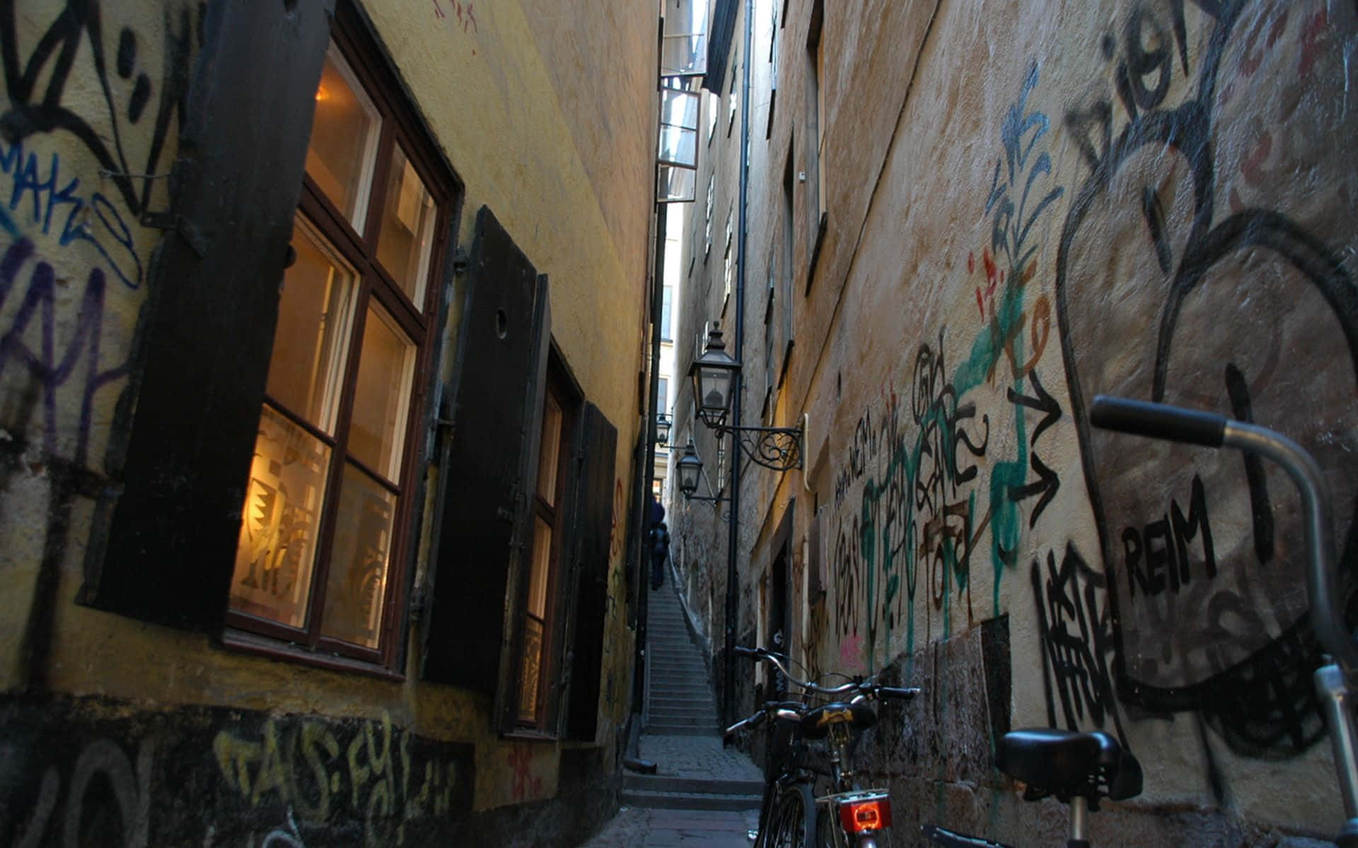 A Bike Parked In A Narrow Alley