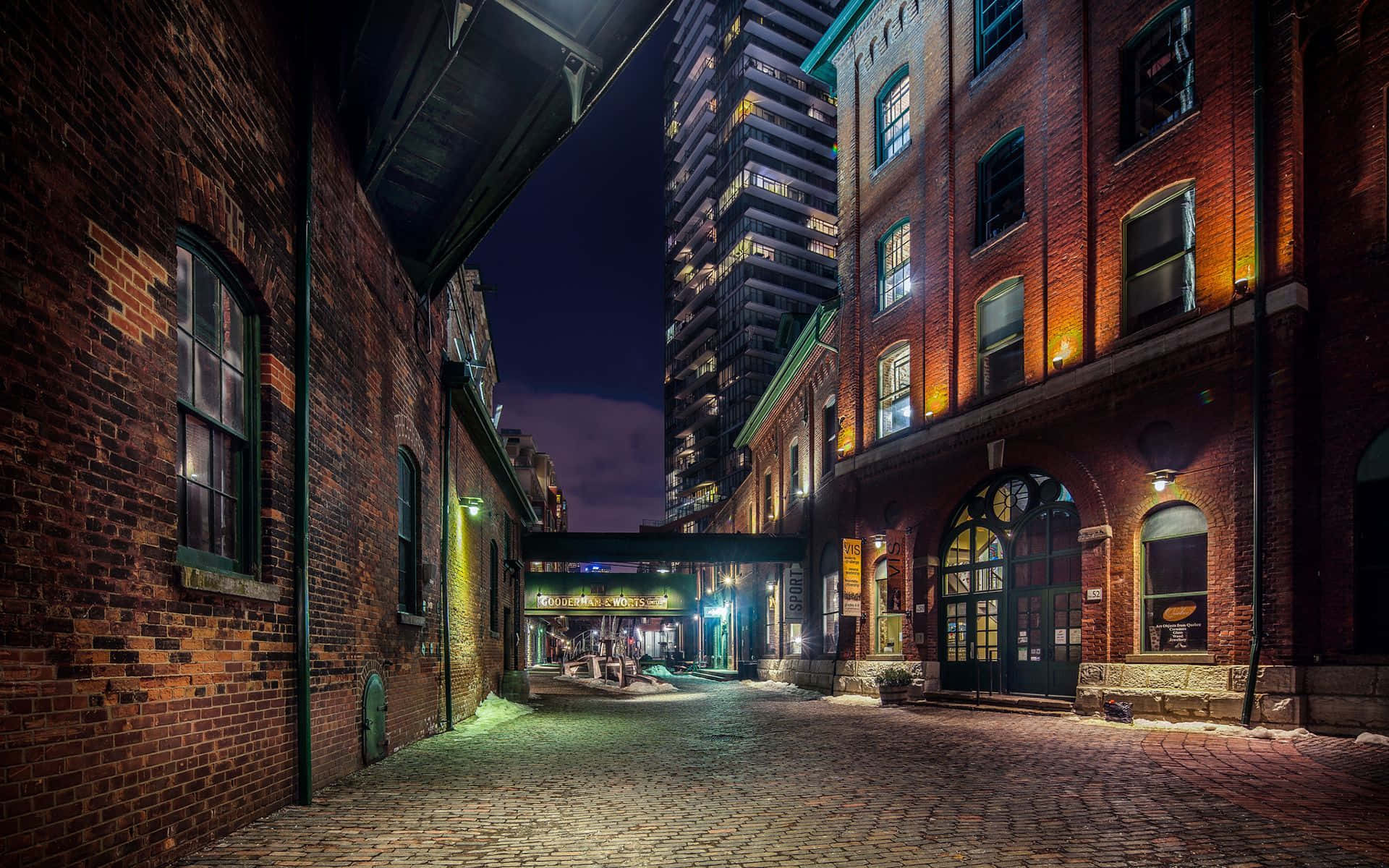 A Brick Alley With A Building In The Background