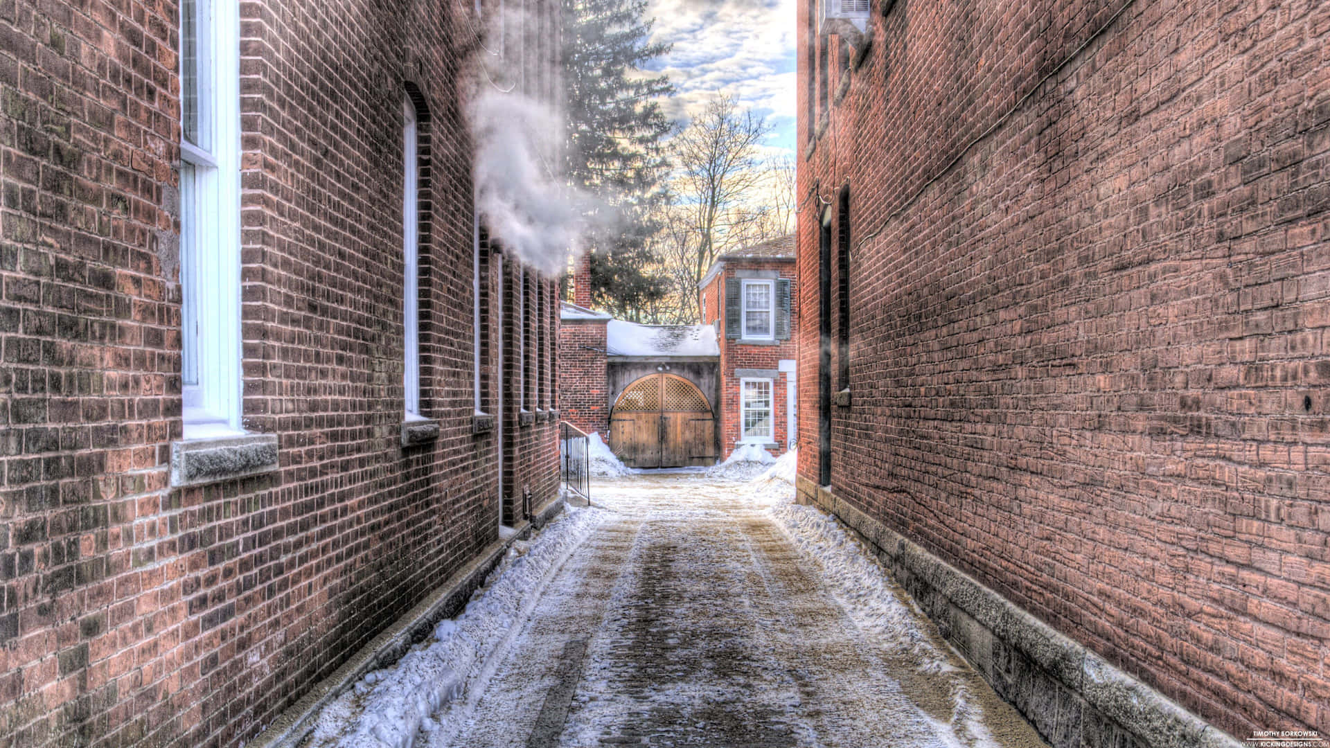 A Narrow Alleyway With Snow On The Ground
