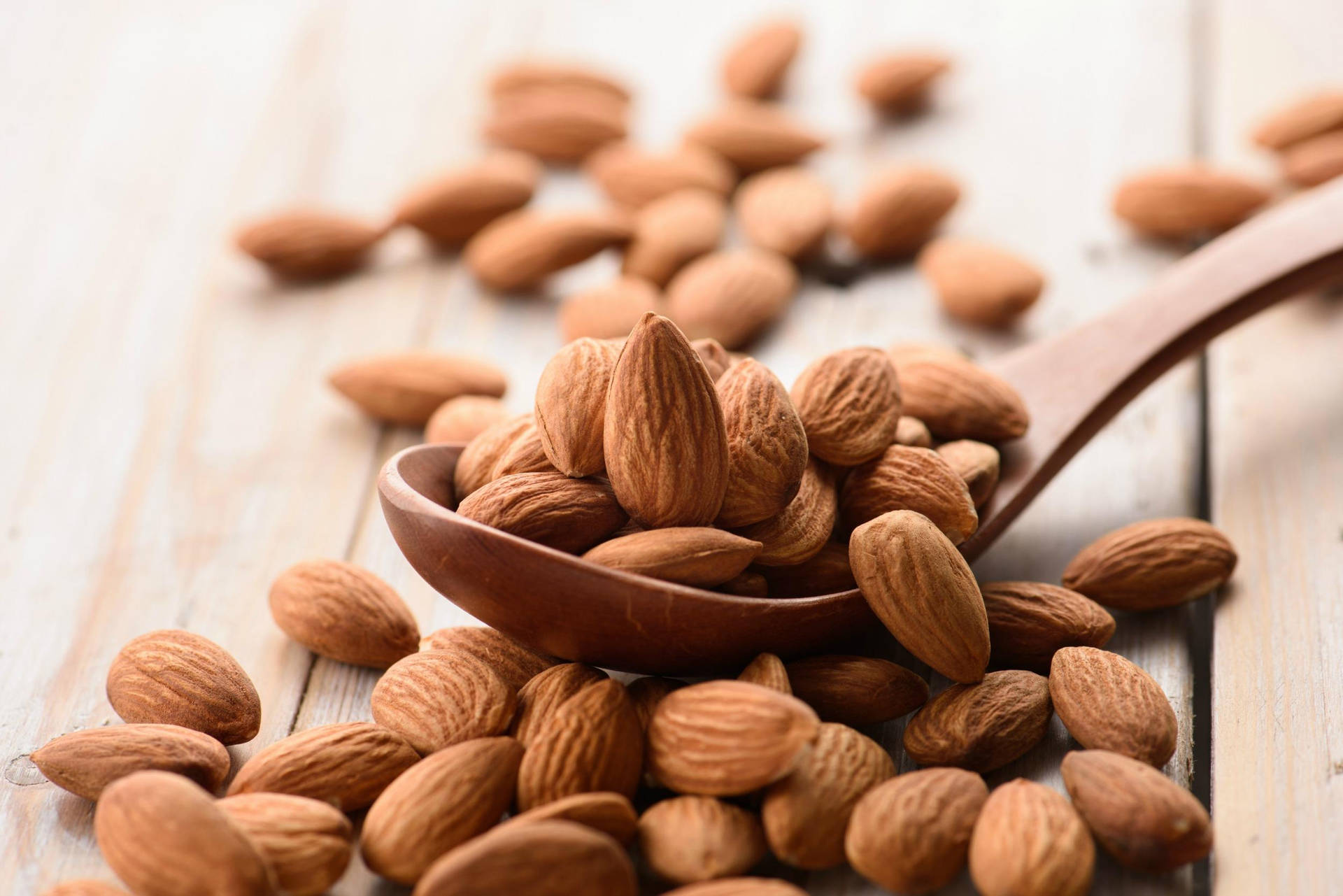 Almond Nuts On Wooden Spoon Wallpaper