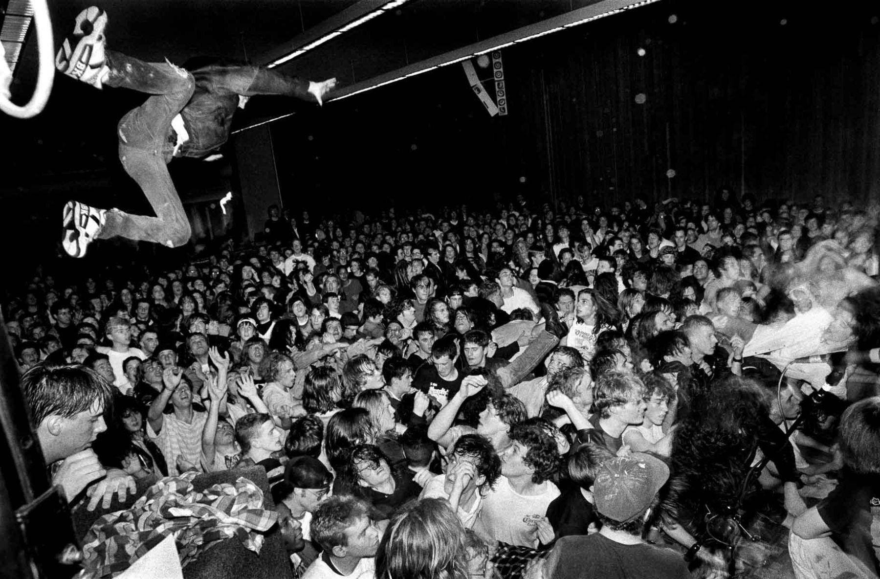 A Man Is Jumping Over A Crowd Of People Wallpaper
