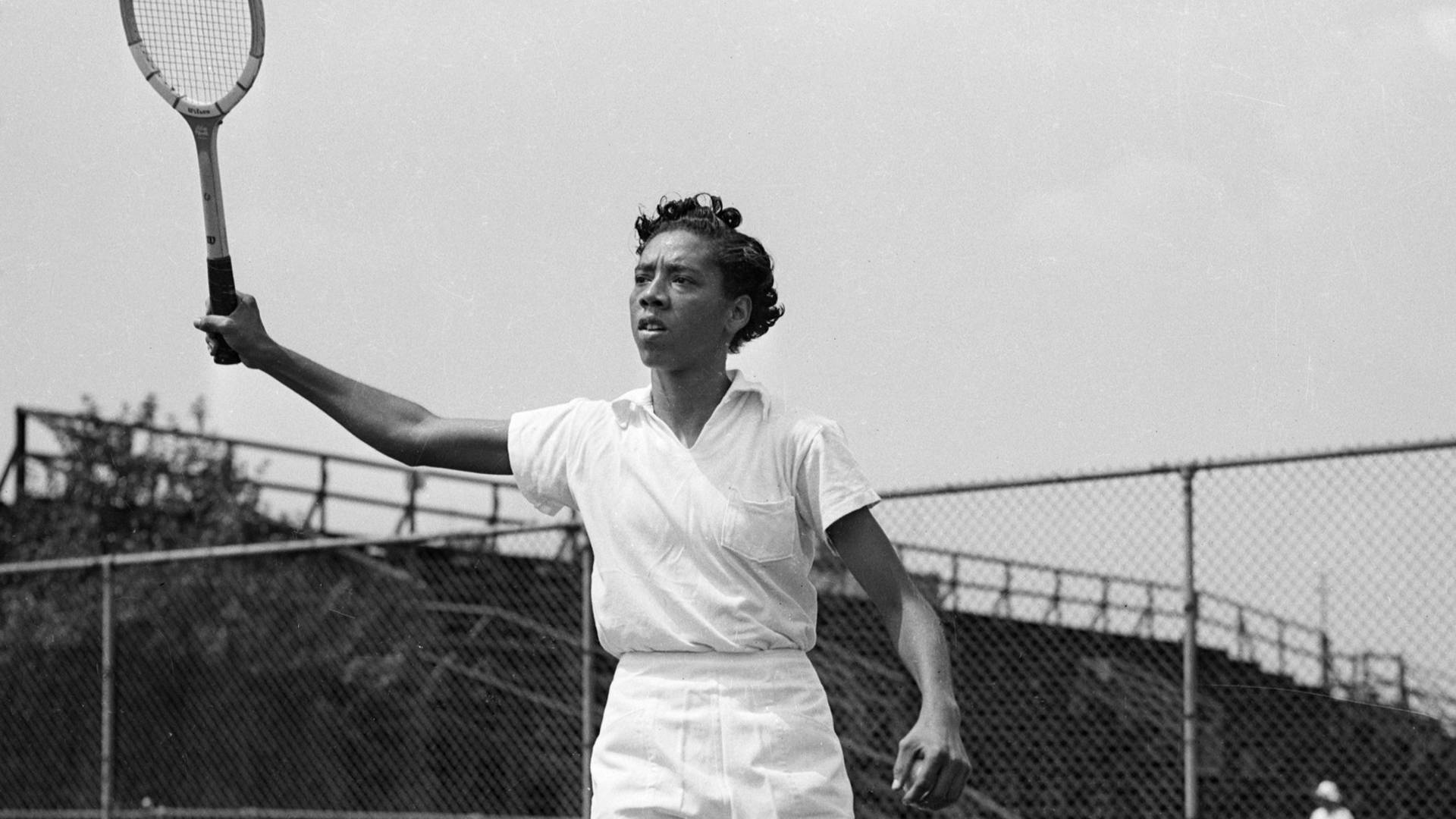 Althea Gibson Swinging in Major Tennis Championships Wallpaper