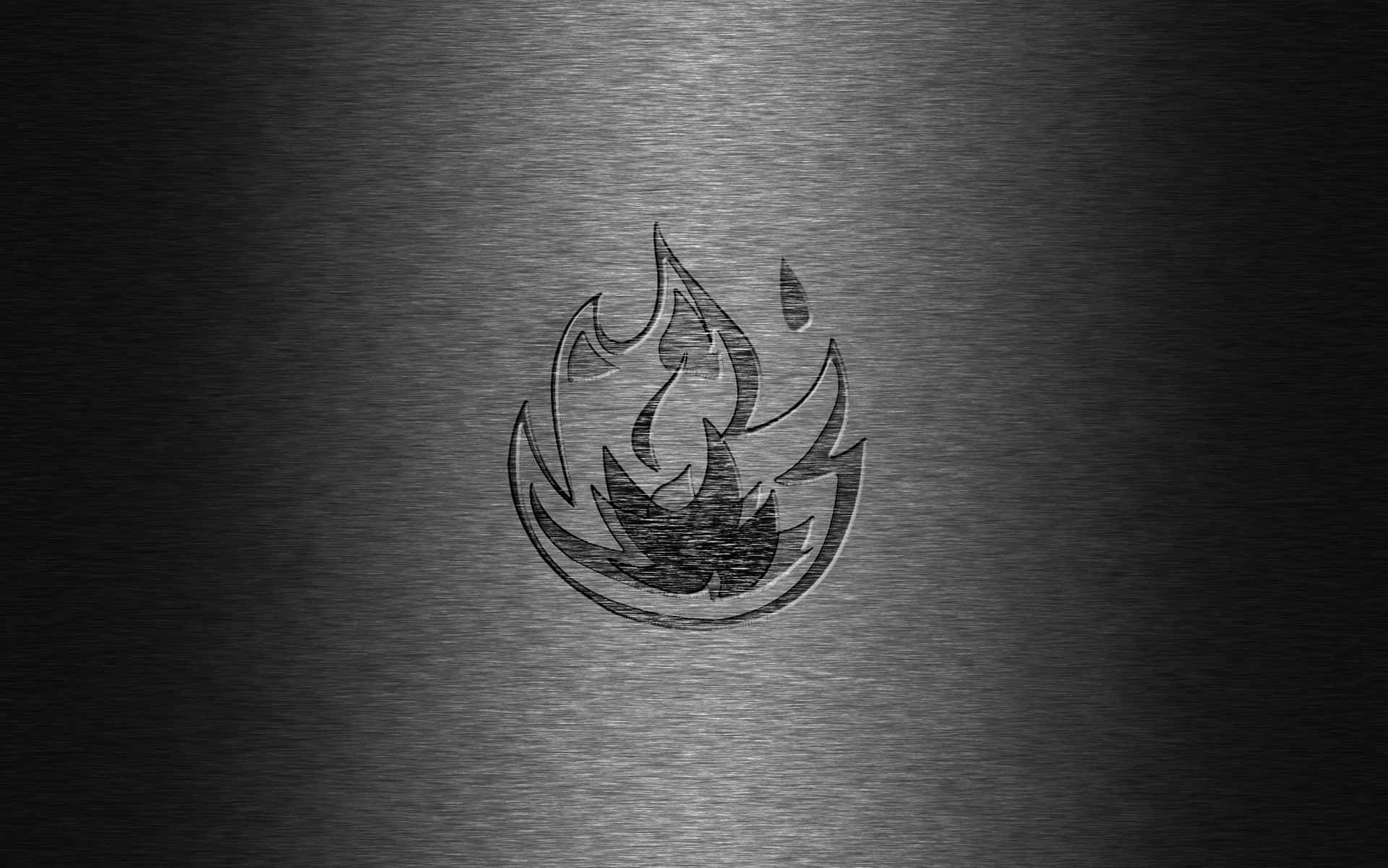 A Black And Silver Metal Logo With Flames