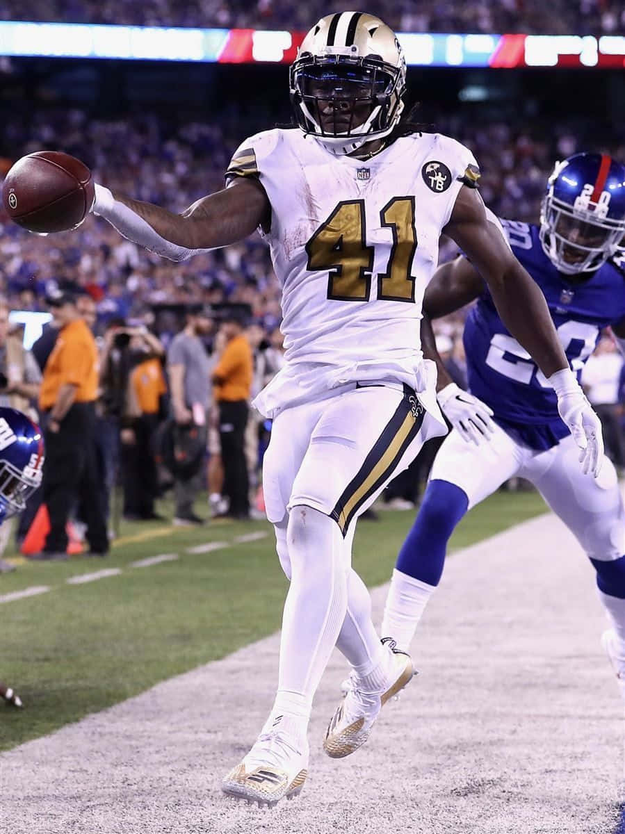 A Football Player Running With The Ball Wallpaper
