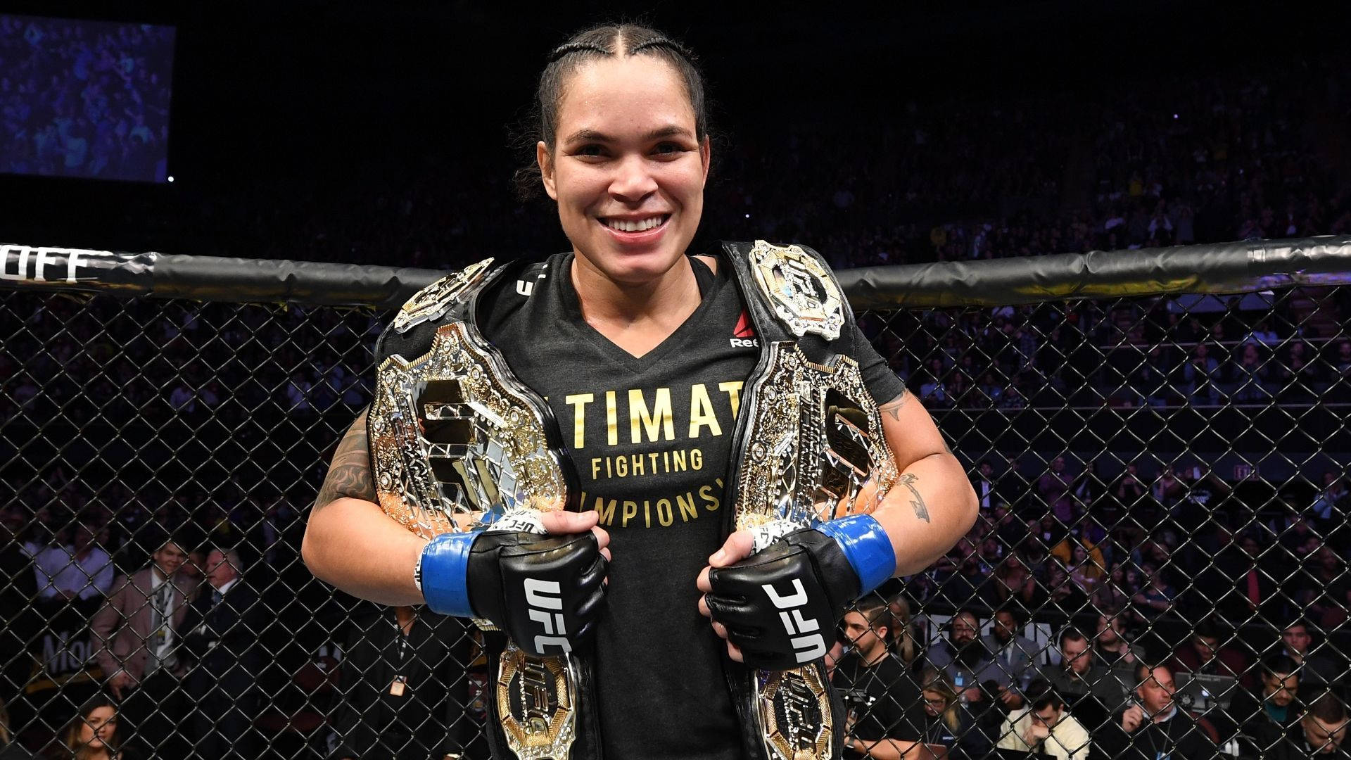 Amandanunes Mästare Smile (this Could Be Used As A Title For A Wallpaper Featuring Amanda Nunes, The Ufc Fighter, With A Victorious Smile After Winning A Championship Fight) Wallpaper
