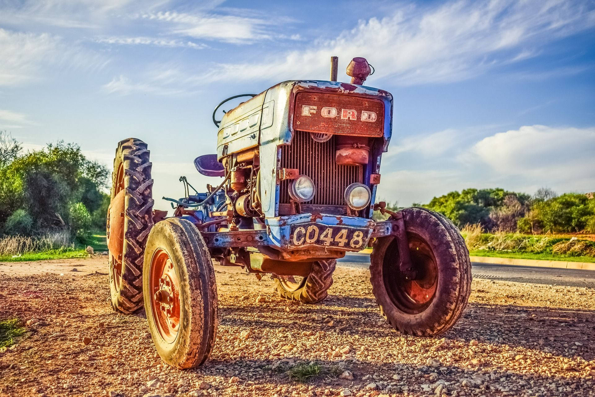 Caption: Classic Ford Tractor in the Field Wallpaper