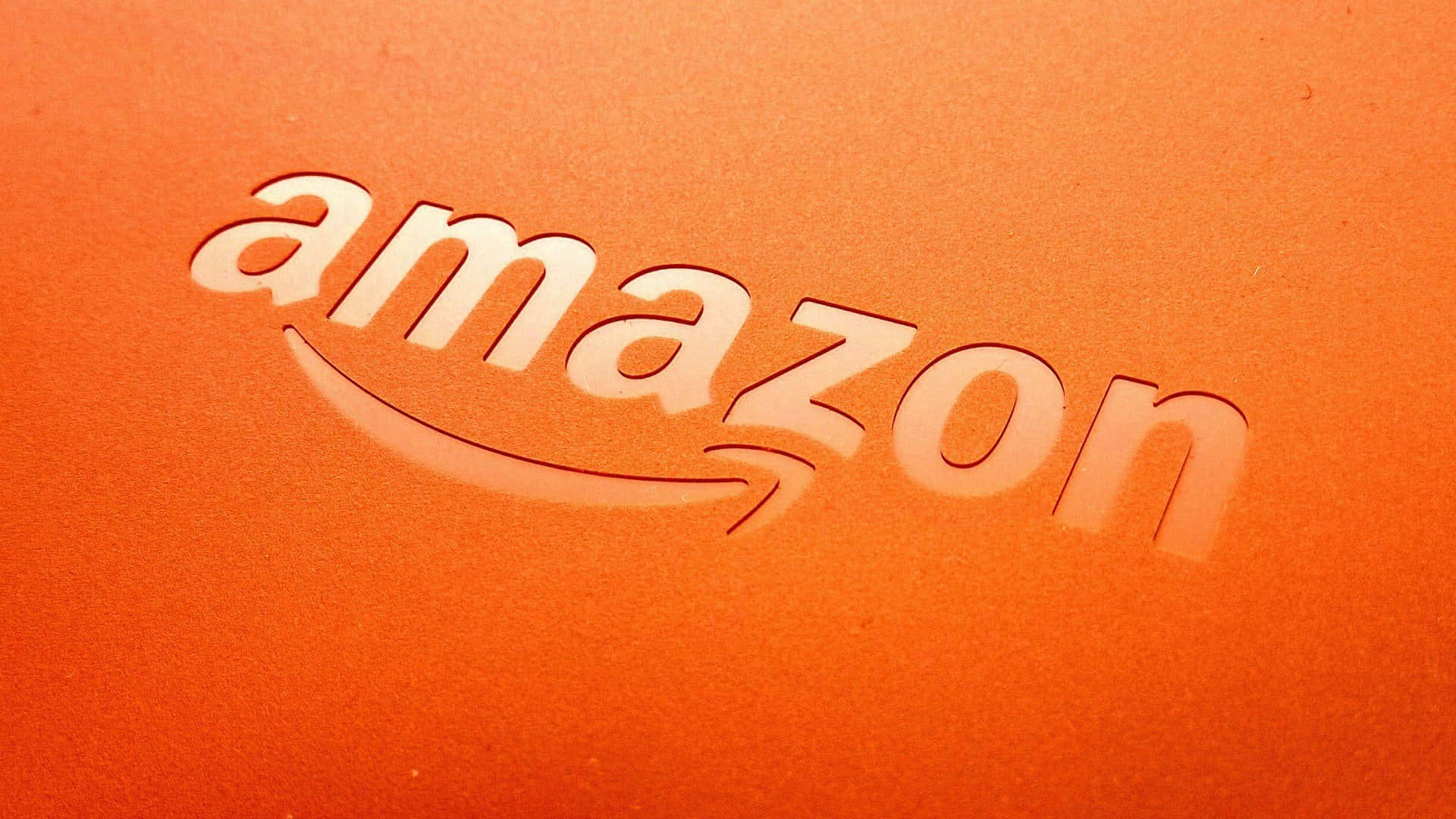 amazon's new logo is shown on an orange background