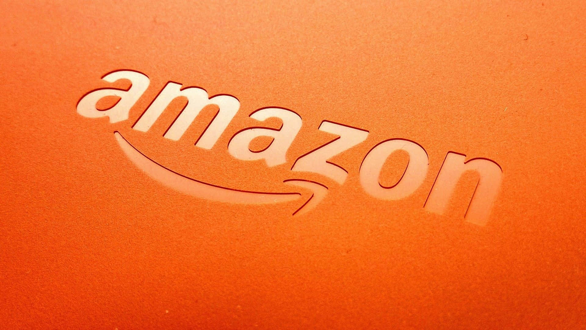 Vibrant Amazon UK Logo Against a Stunning Orange Backdrop Wallpaper