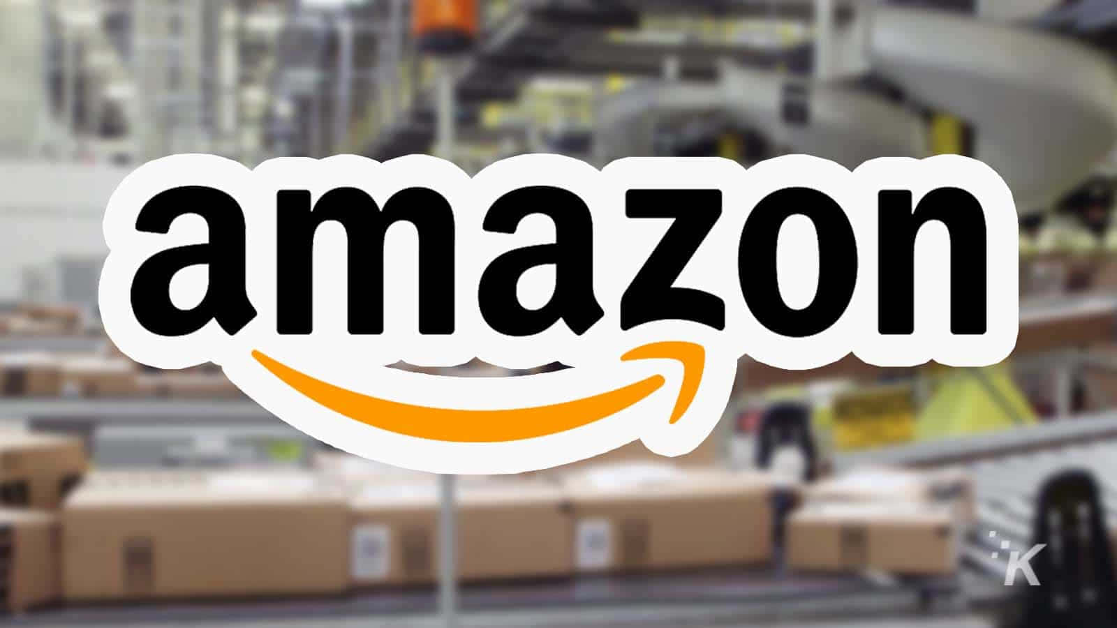 Amazon UK Logo Against Blurry Warehouse Wallpaper