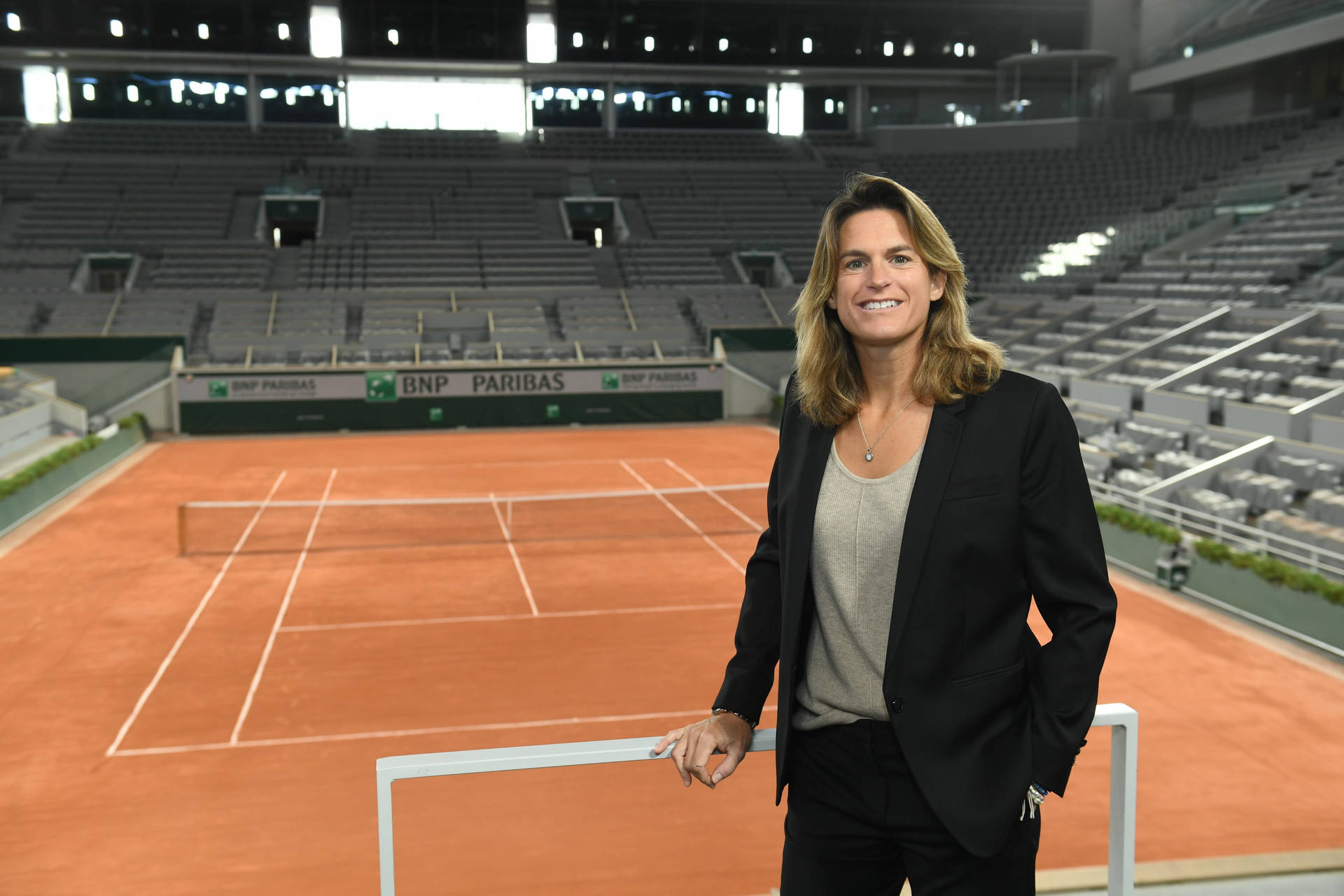 Amélie Mauresmo Posing Near Tennis Court Wallpaper