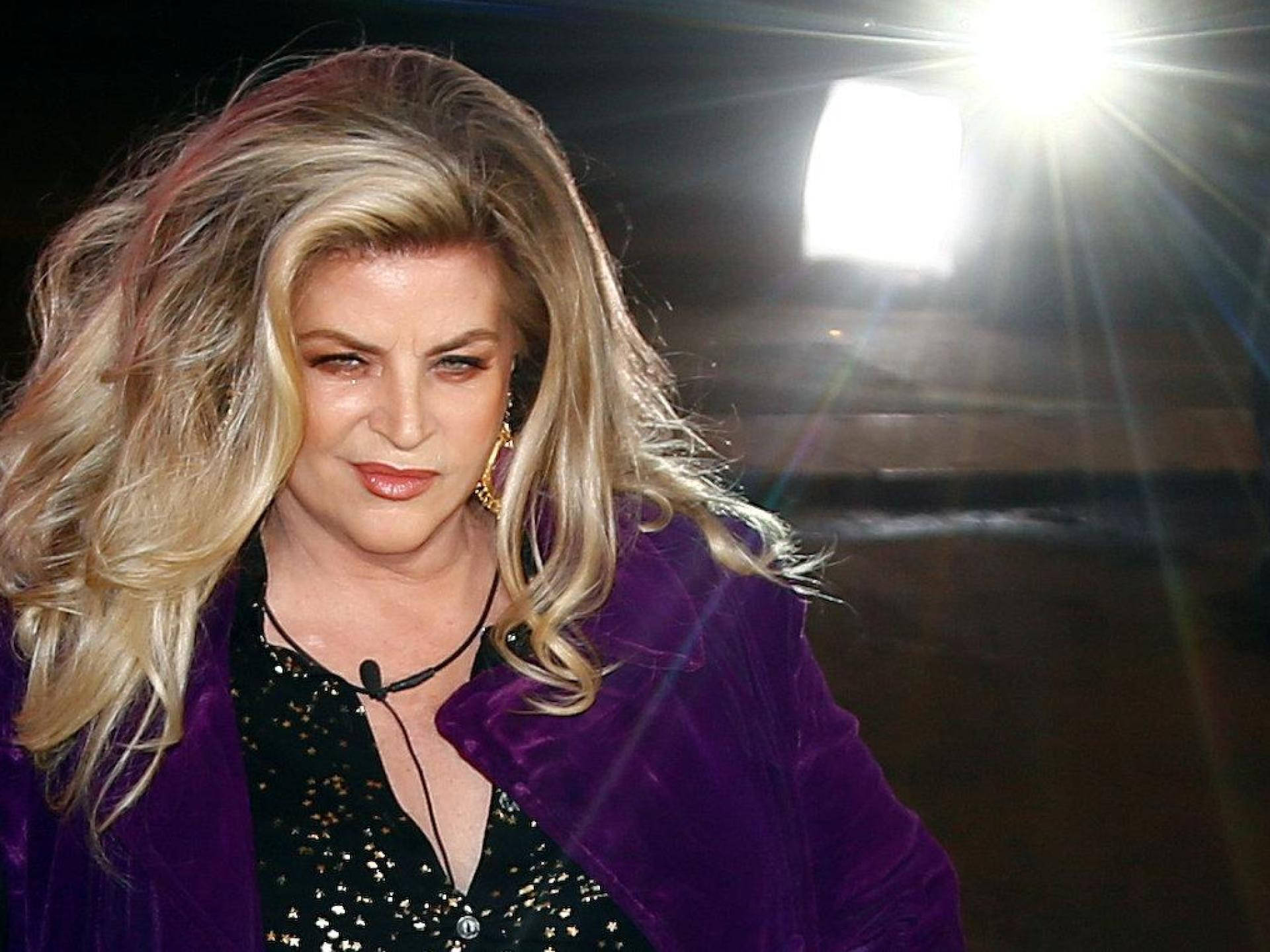 American Actress Kirstie Alley On A Spotlight Background