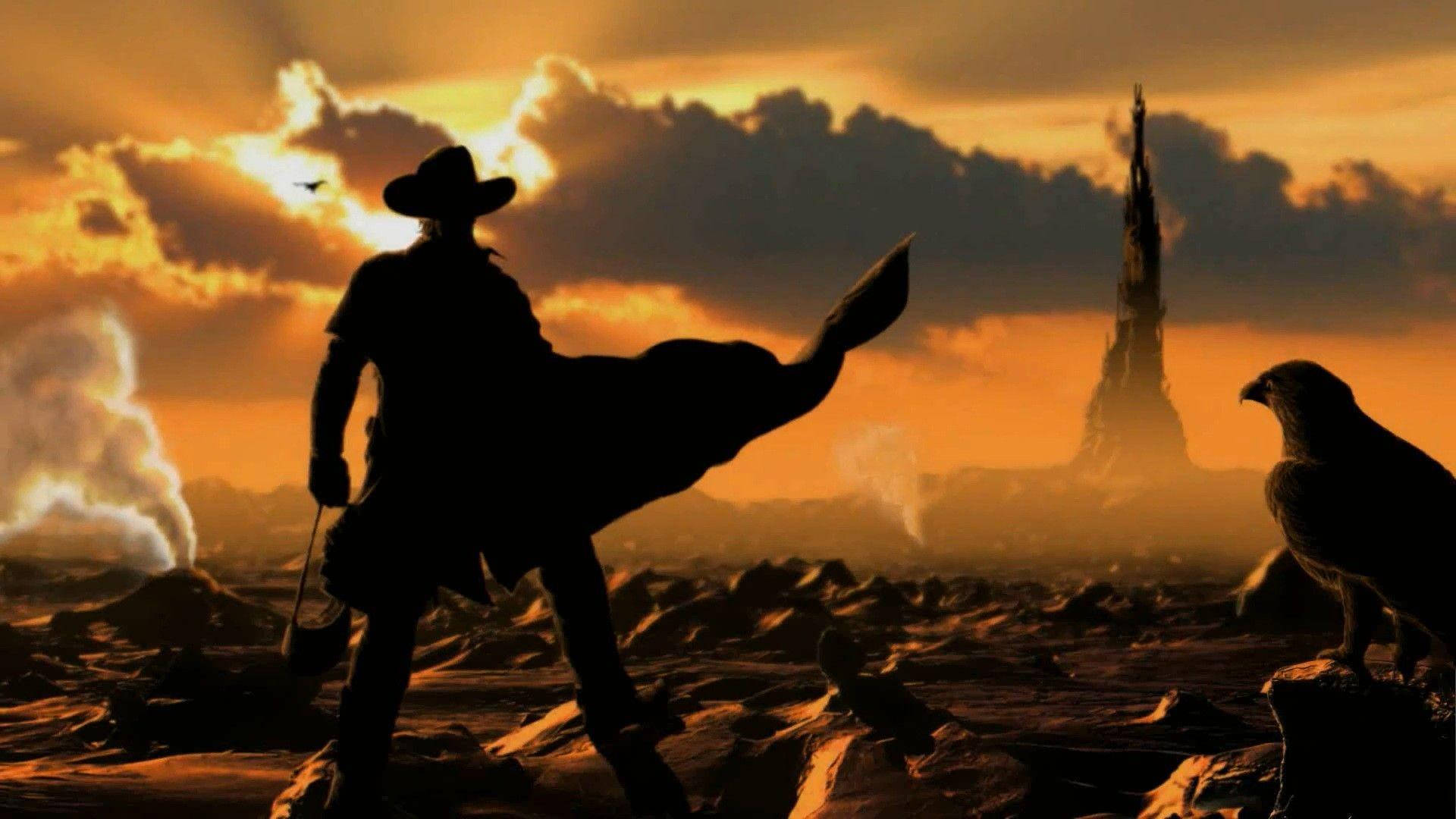 Unhombre Con Un Sombrero De Vaquero Está Parado Frente A Una Torre. Fondo de pantalla